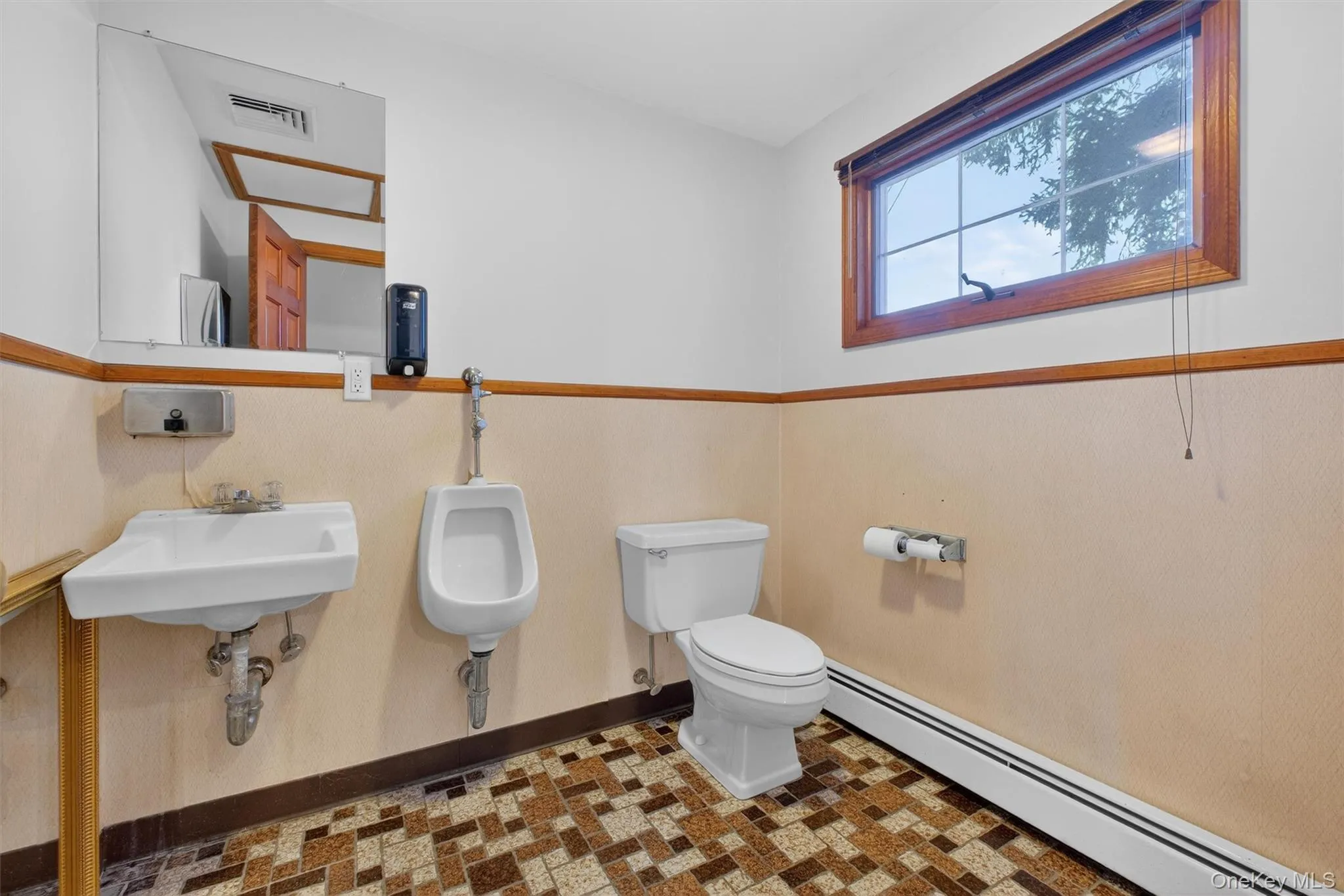 Bathroom with baseboard heating and toilet Bathroom with baseboard heating and toilet