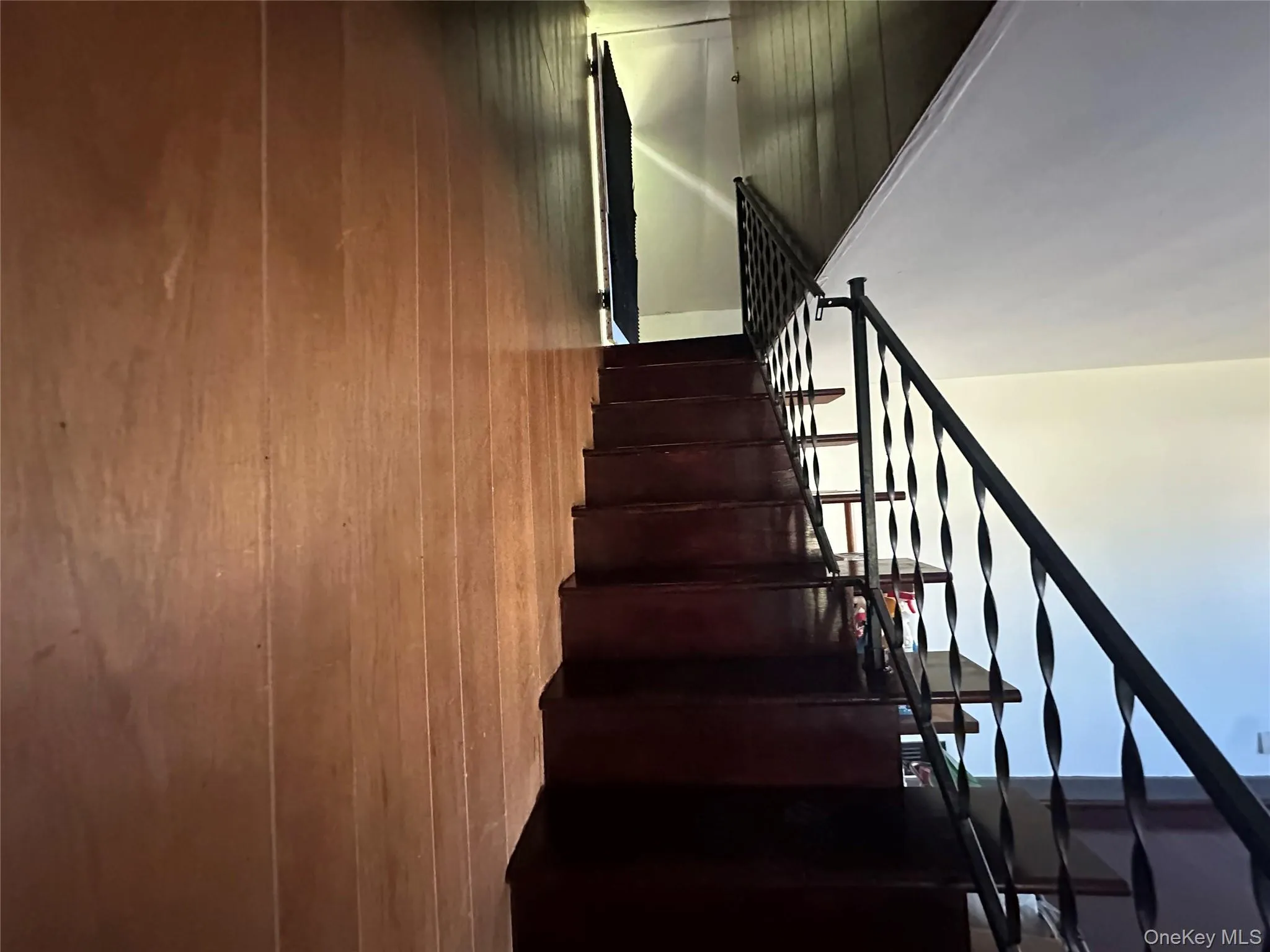 Staircase featuring wood walls Staircase featuring wood walls