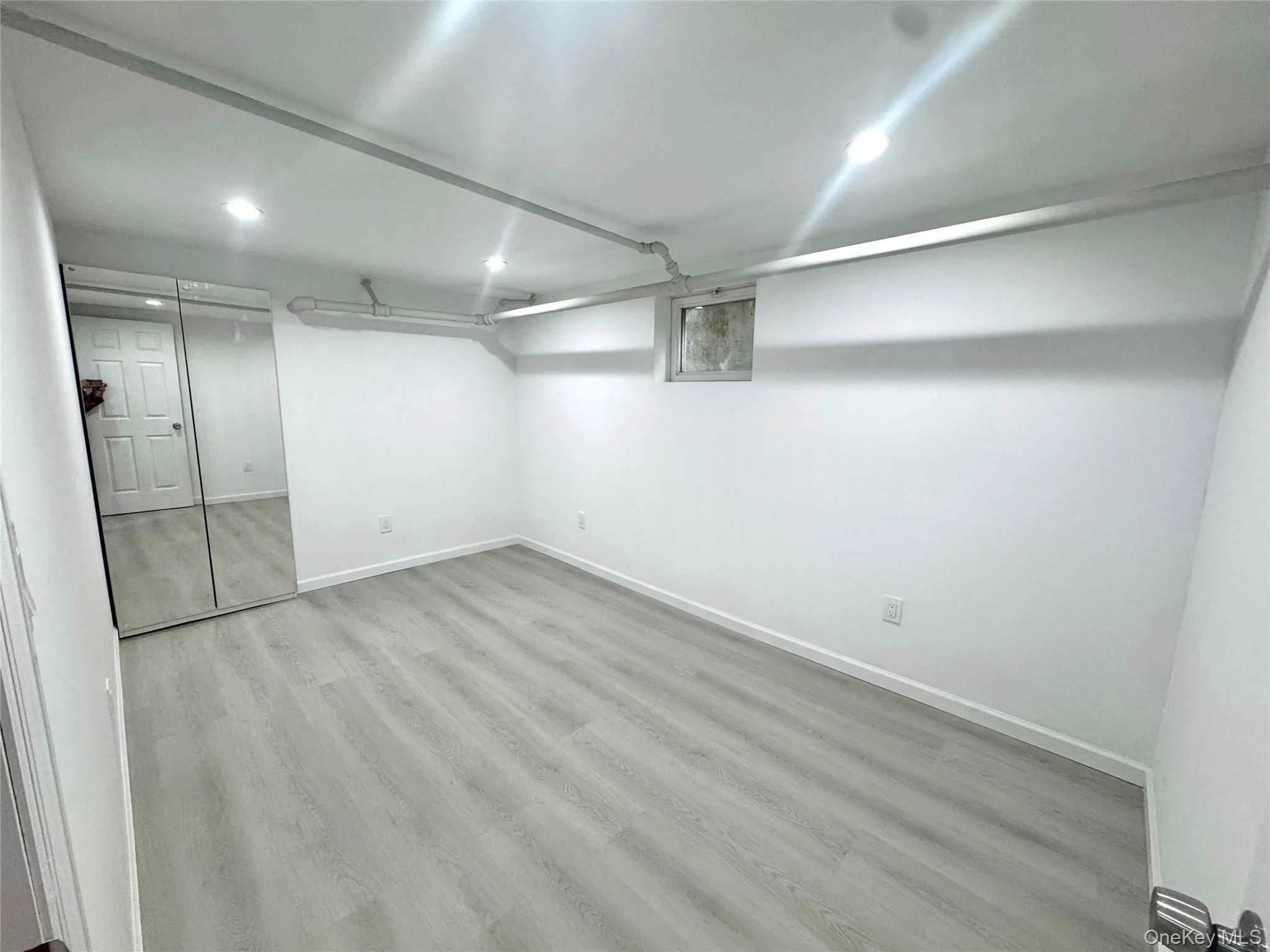 Finished basement featuring light wood-style flooring and recessed lighting Finished basement featuring light wood-style flooring and recessed lighting