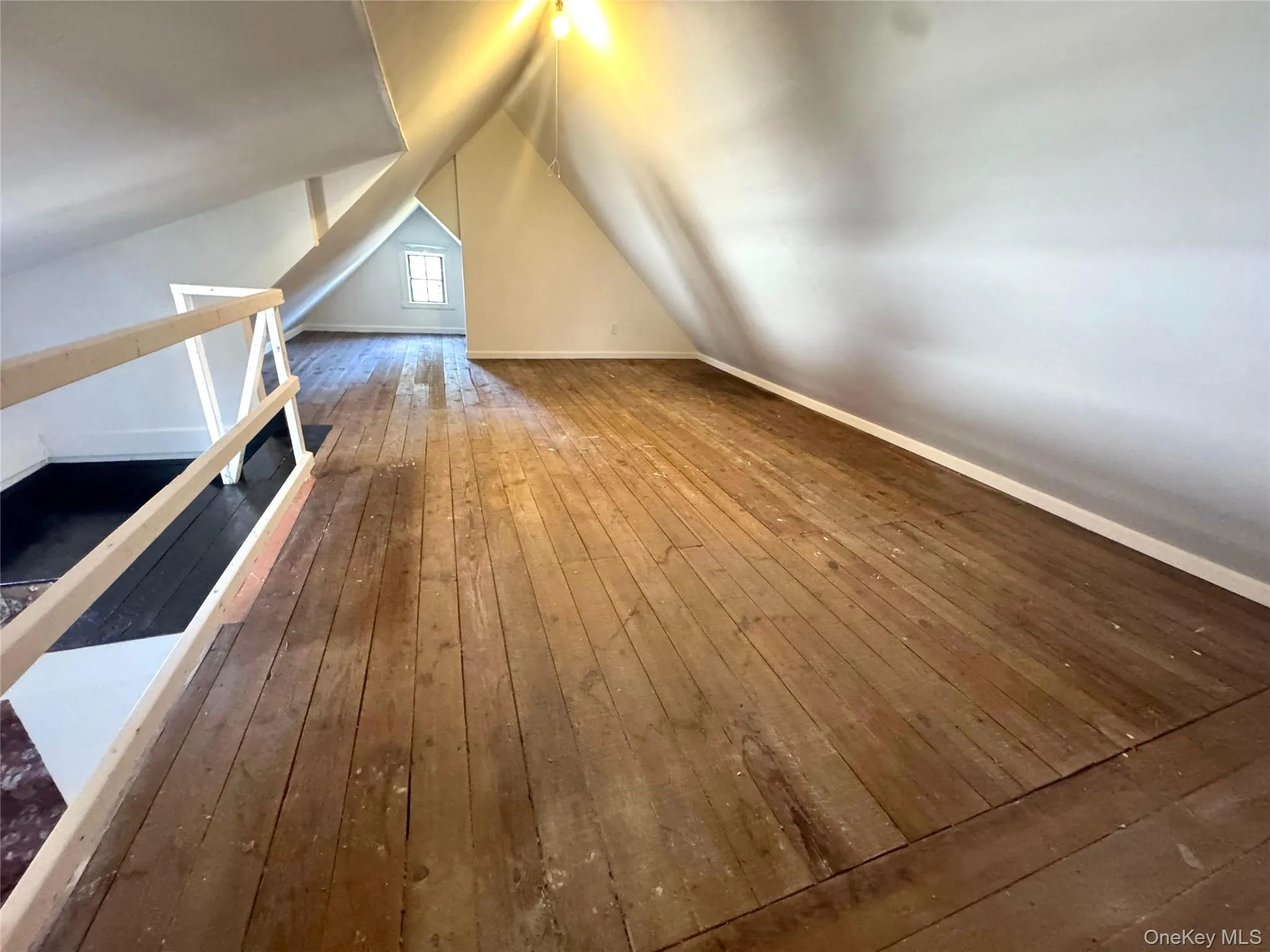 Bonus room with wood-type flooring and lofted ceiling Bonus room with wood-type flooring and lofted ceiling