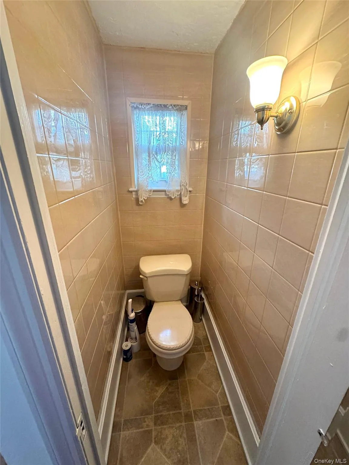 Bathroom featuring tile walls and tile patterned flooring Bathroom featuring tile walls and tile patterned flooring