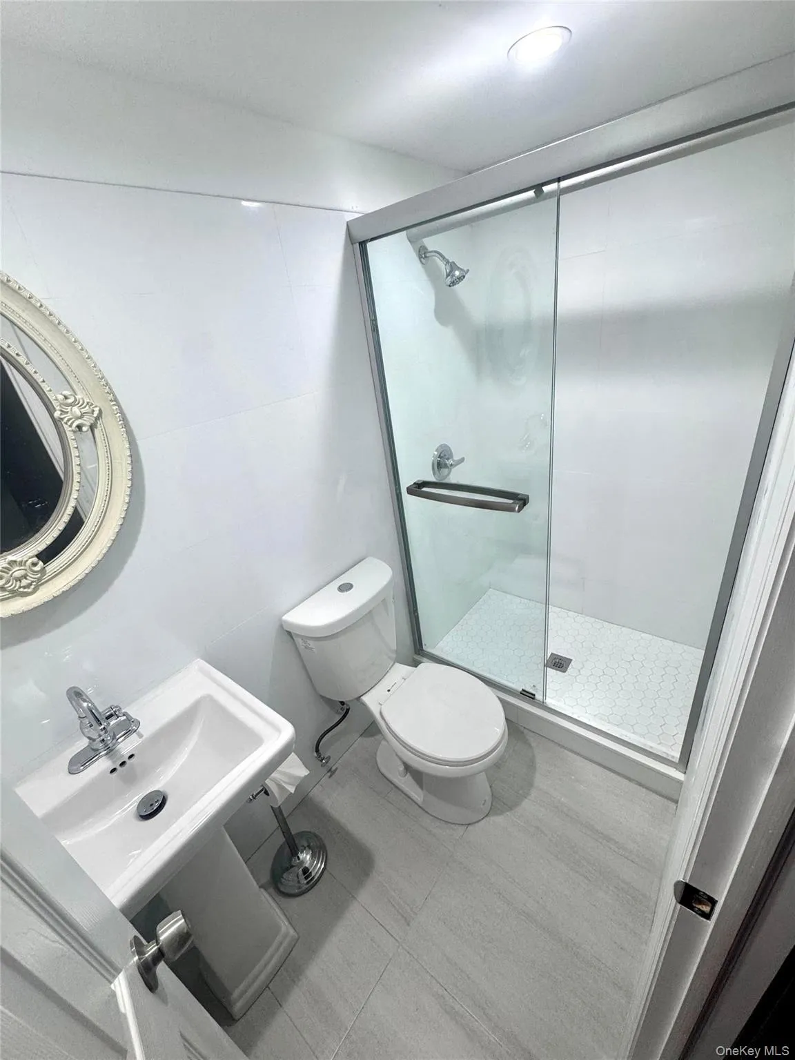 Full bath with tile walls and a stall shower Full bath with tile walls and a stall shower