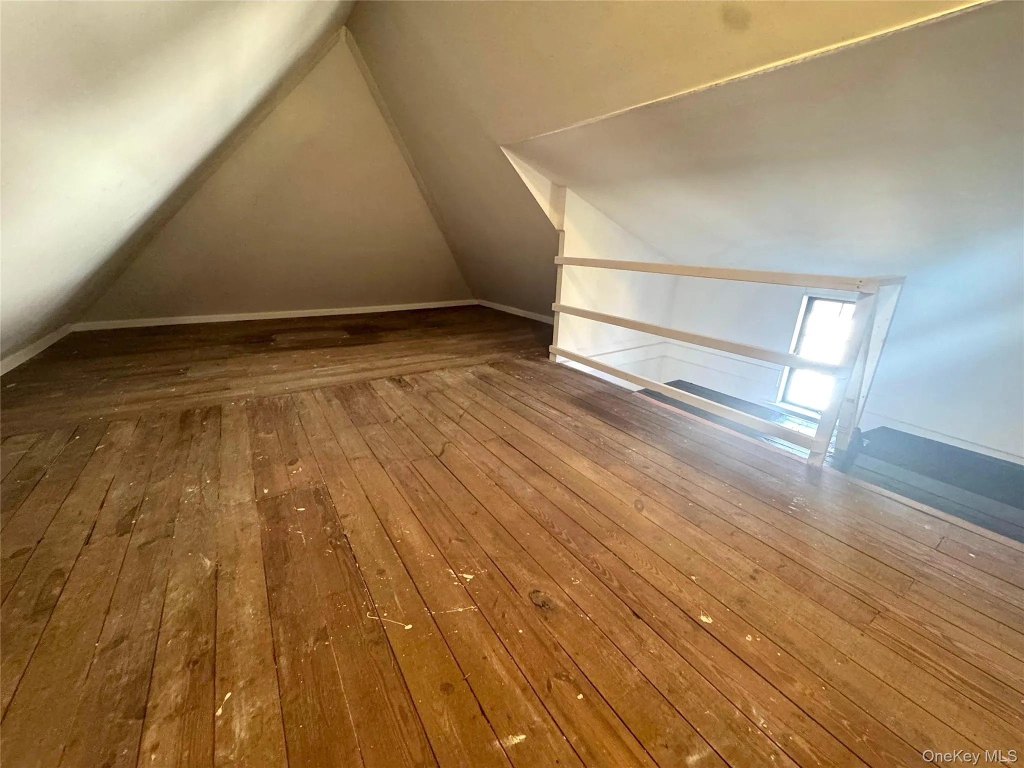 Bonus room with lofted ceiling and hardwood / wood-style flooring Bonus room with lofted ceiling and hardwood / wood-style flooring