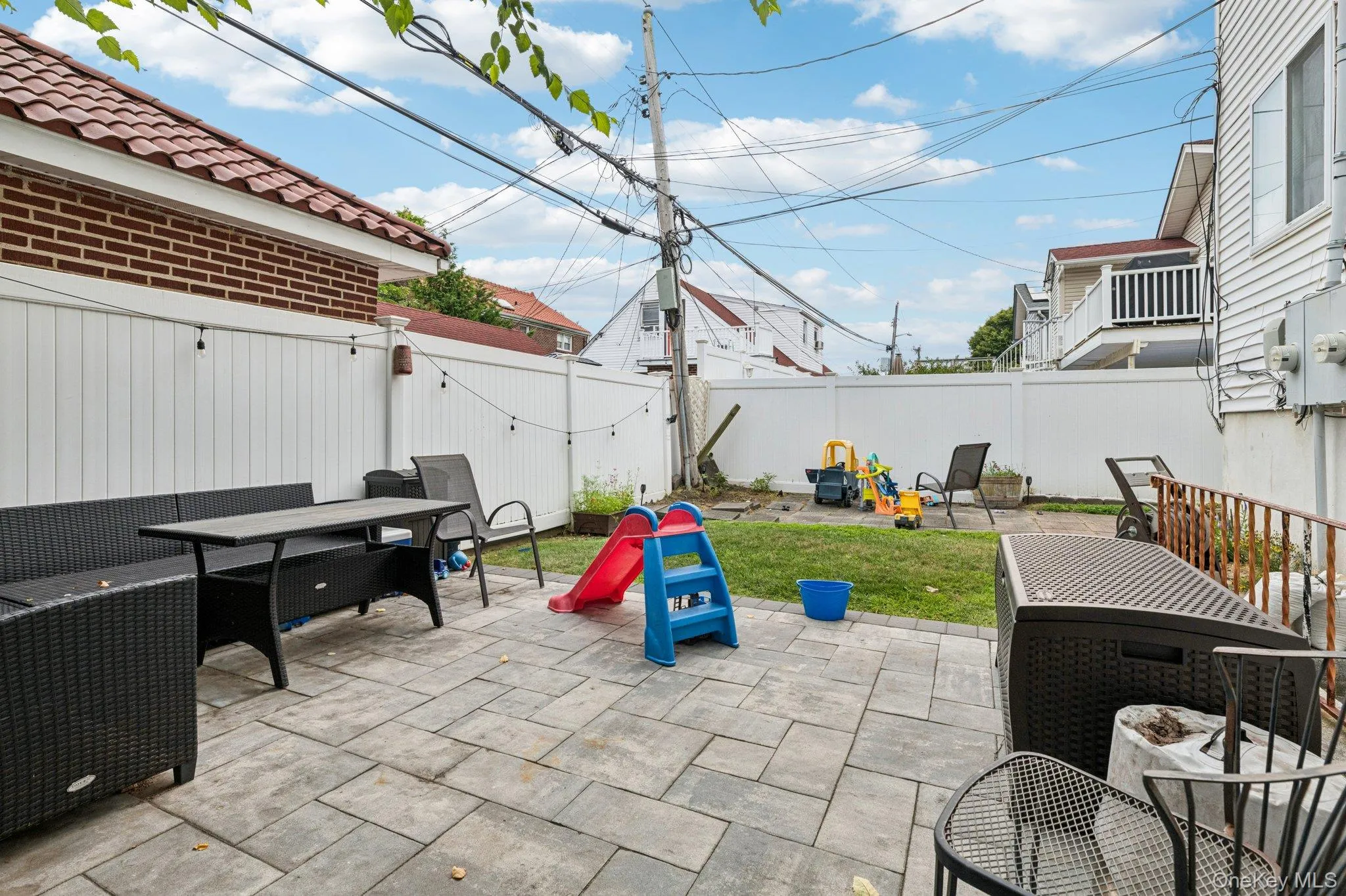 Fenced backyard featuring outdoor dining area and a patio Fenced backyard featuring outdoor dining area and a patio