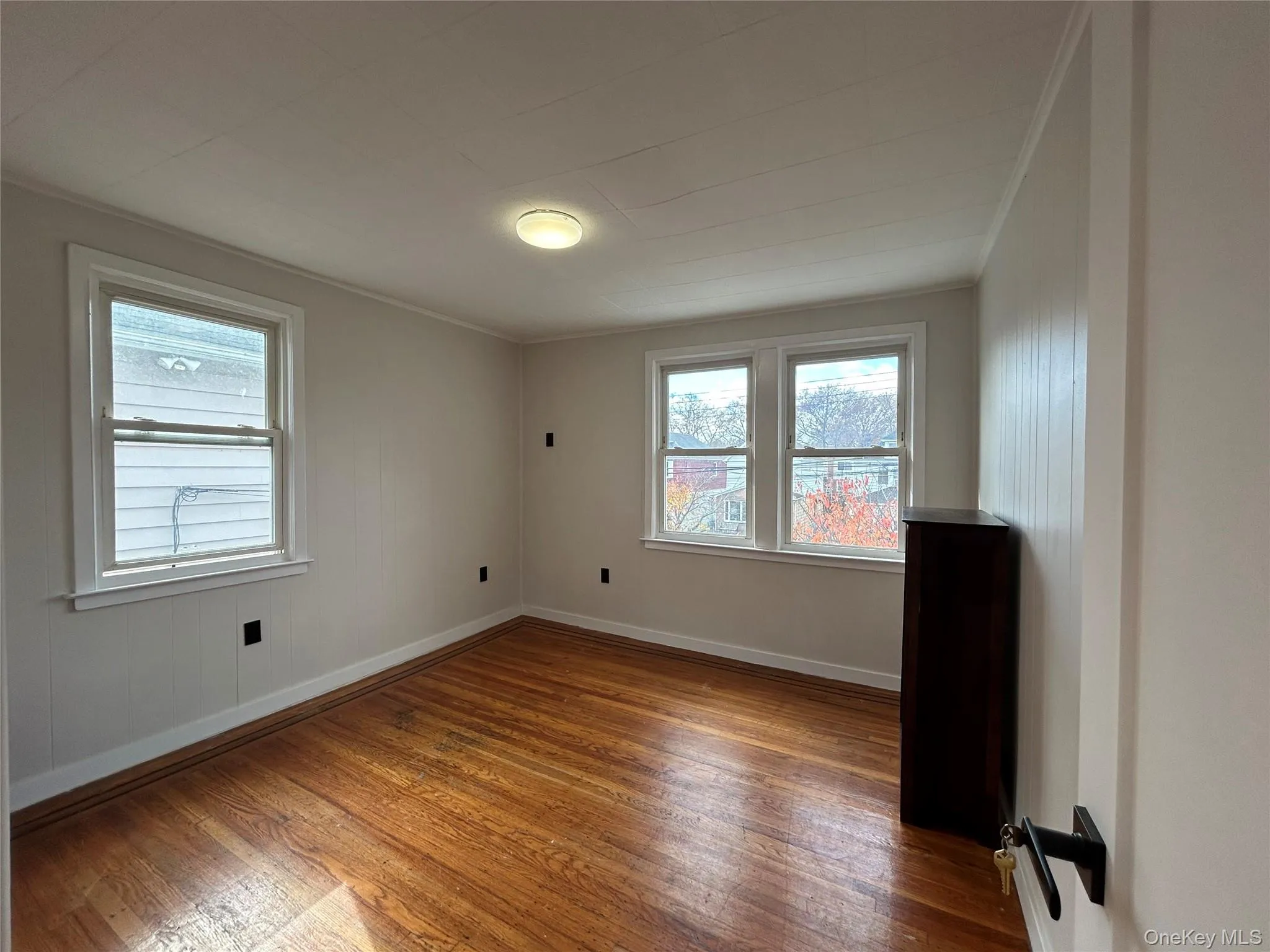 Spare room with hardwood / wood-style flooring, healthy amount of natural light, and crown molding Spare room with hardwood / wood-style flooring, healthy amount of natural light, and crown molding