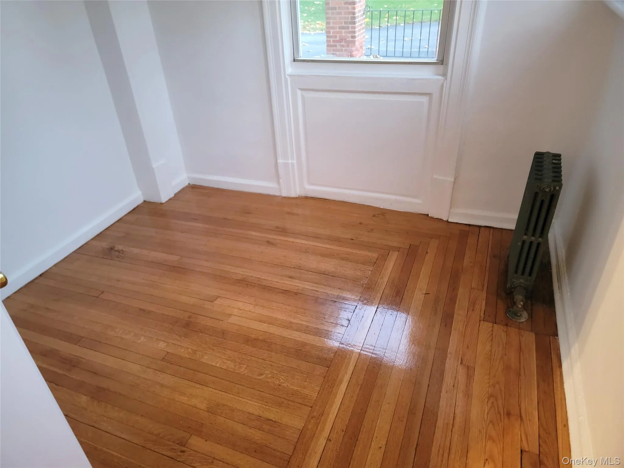 Spare room featuring radiator heating unit and baseboards Spare room featuring radiator heating unit and baseboards