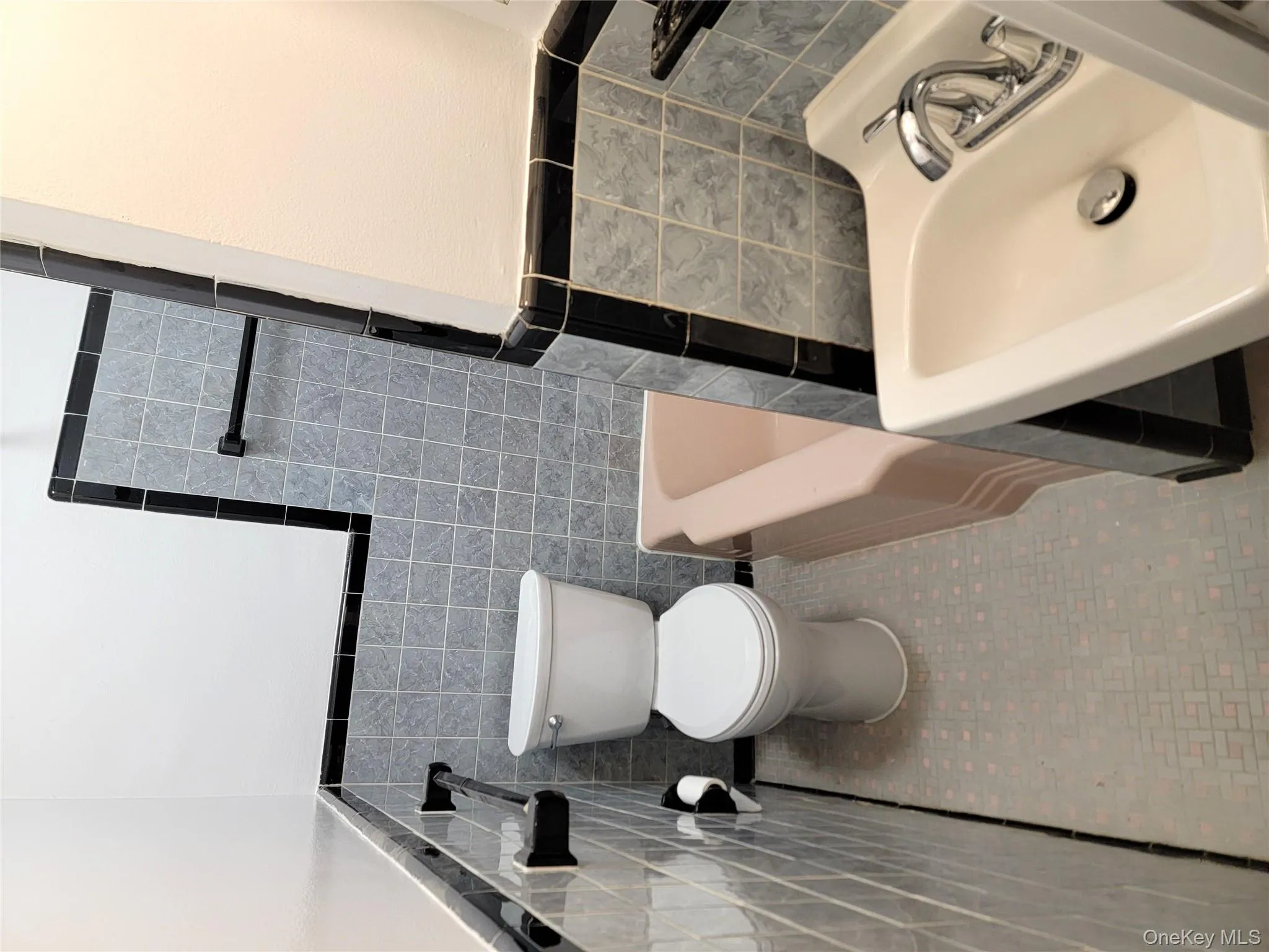 Full bath with tile walls, wainscoting, and tile patterned flooring Full bath with tile walls, wainscoting, and tile patterned flooring