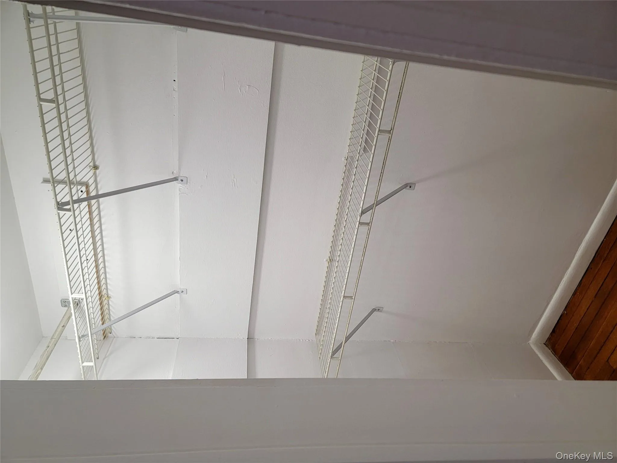 Spacious closet with dark wood finished floors Spacious closet with dark wood finished floors