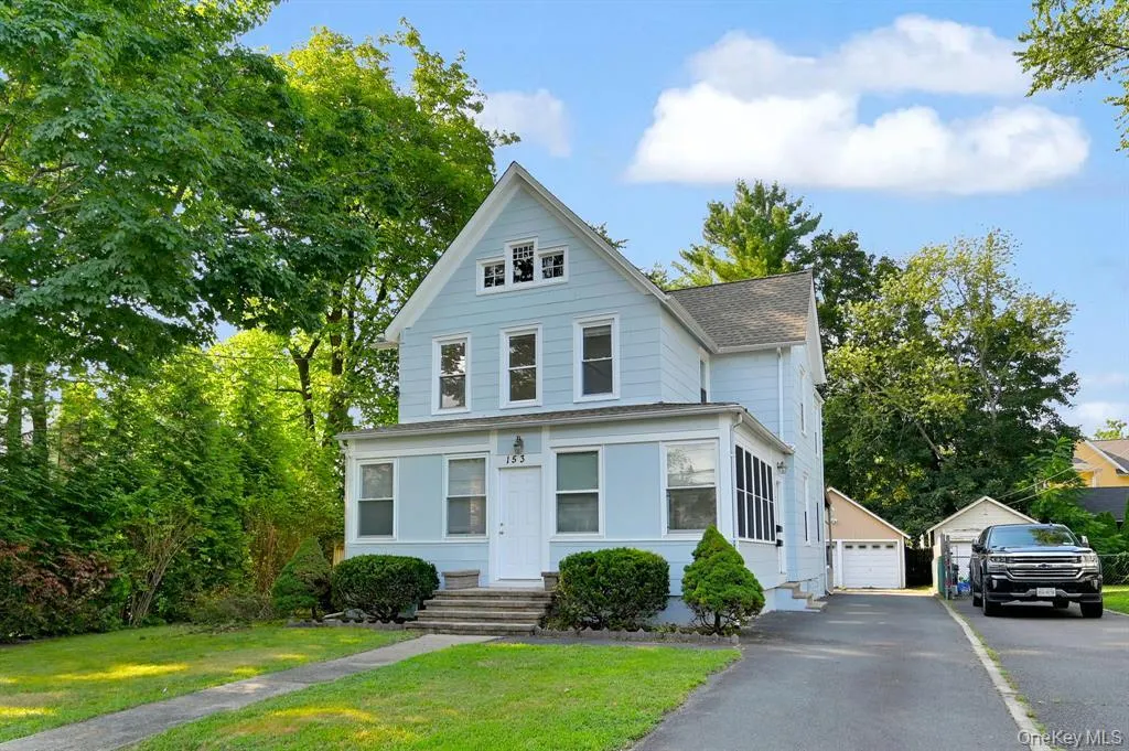 View of front of home featuring a front lawn, an outbuilding, and a detached garage View of front of home featuring a front lawn, an outbuilding, and a detached garage