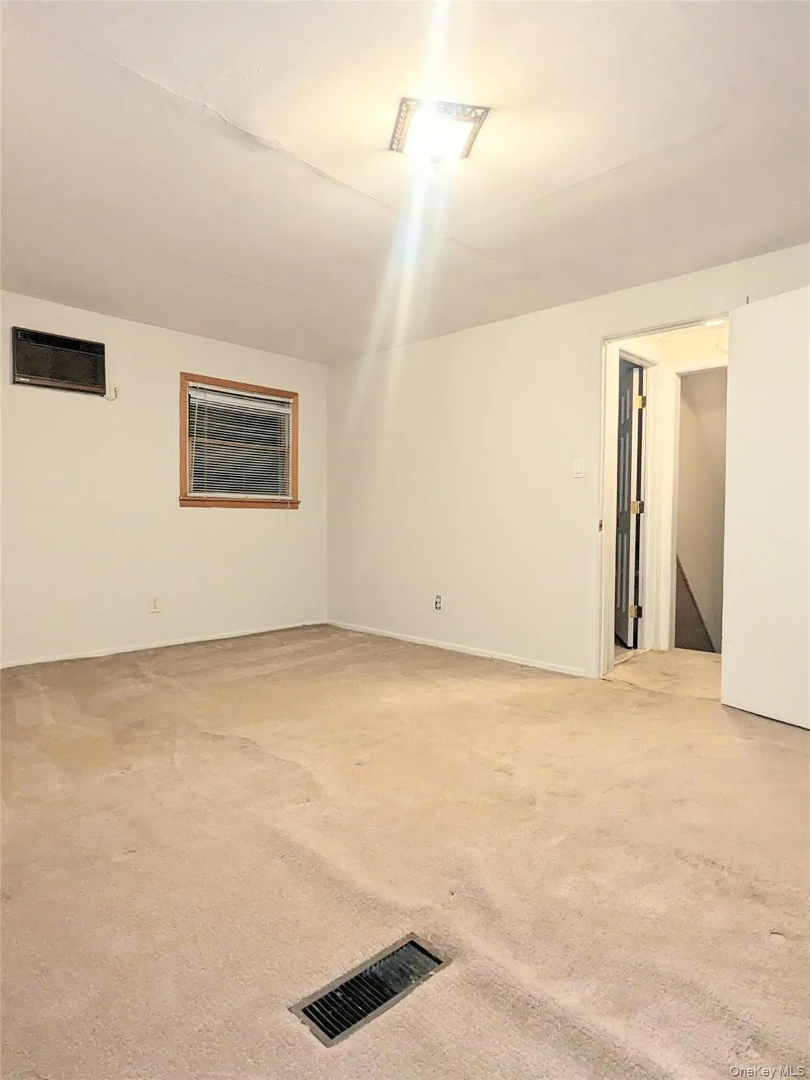 Empty room with light colored carpet Empty room with light colored carpet