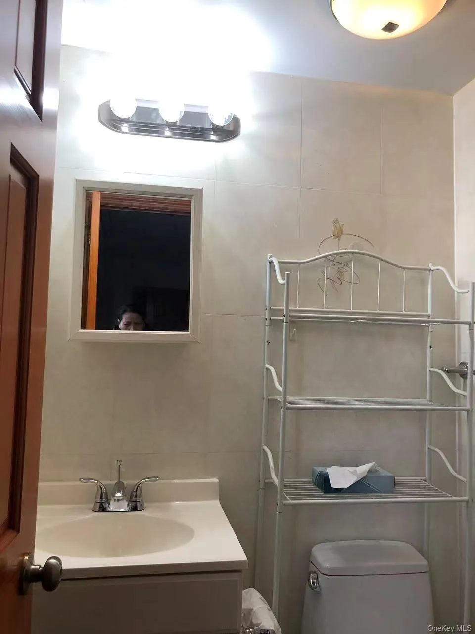 Half bath with vanity and tile walls Half bath with vanity and tile walls