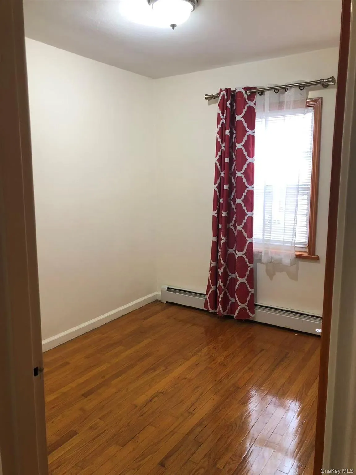 Spare room featuring dark wood finished floors and baseboards Spare room featuring dark wood finished floors and baseboards