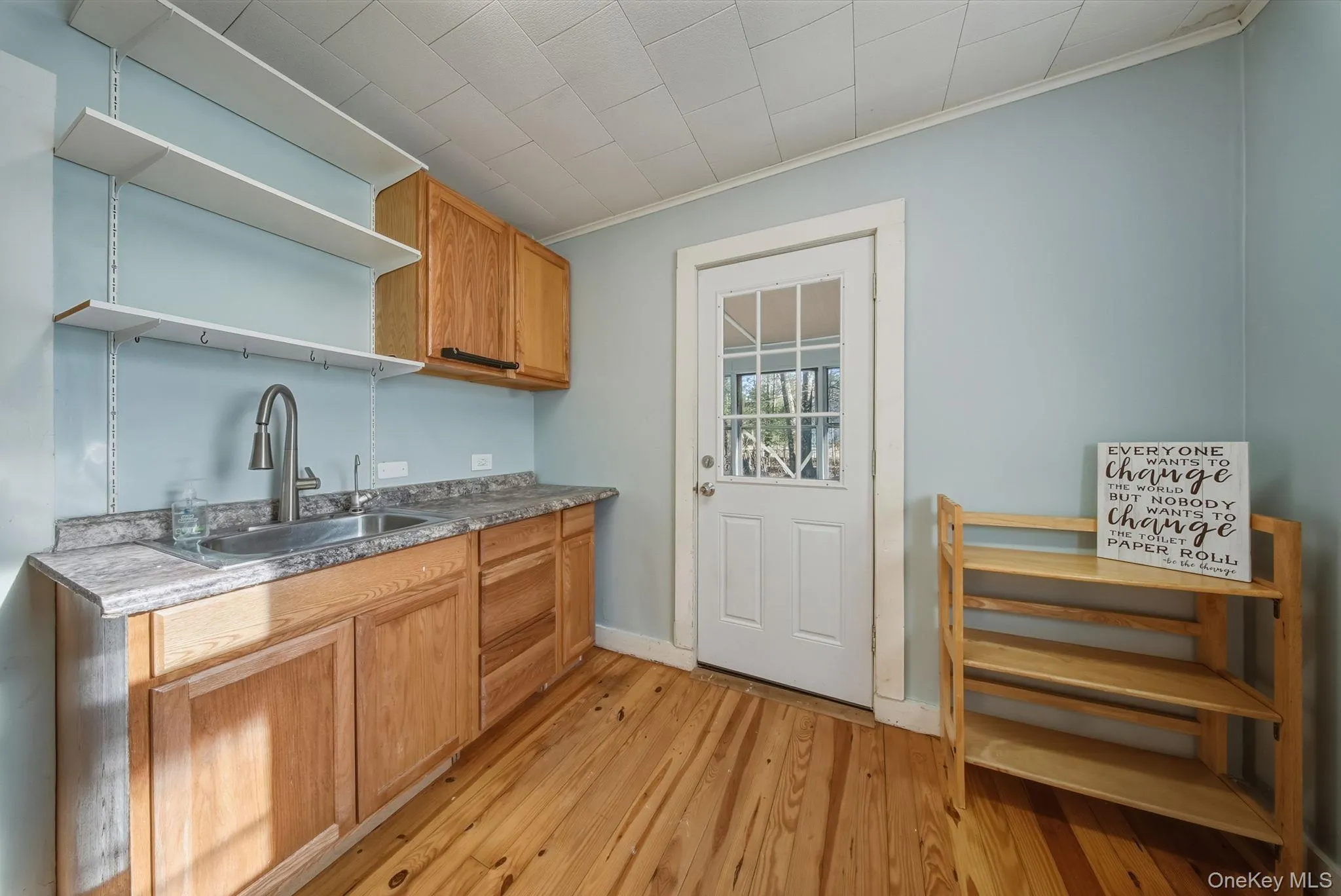 Kitchen featuring open shelves, light wood-style floors, Kitchen featuring open shelves, light wood-style floors,