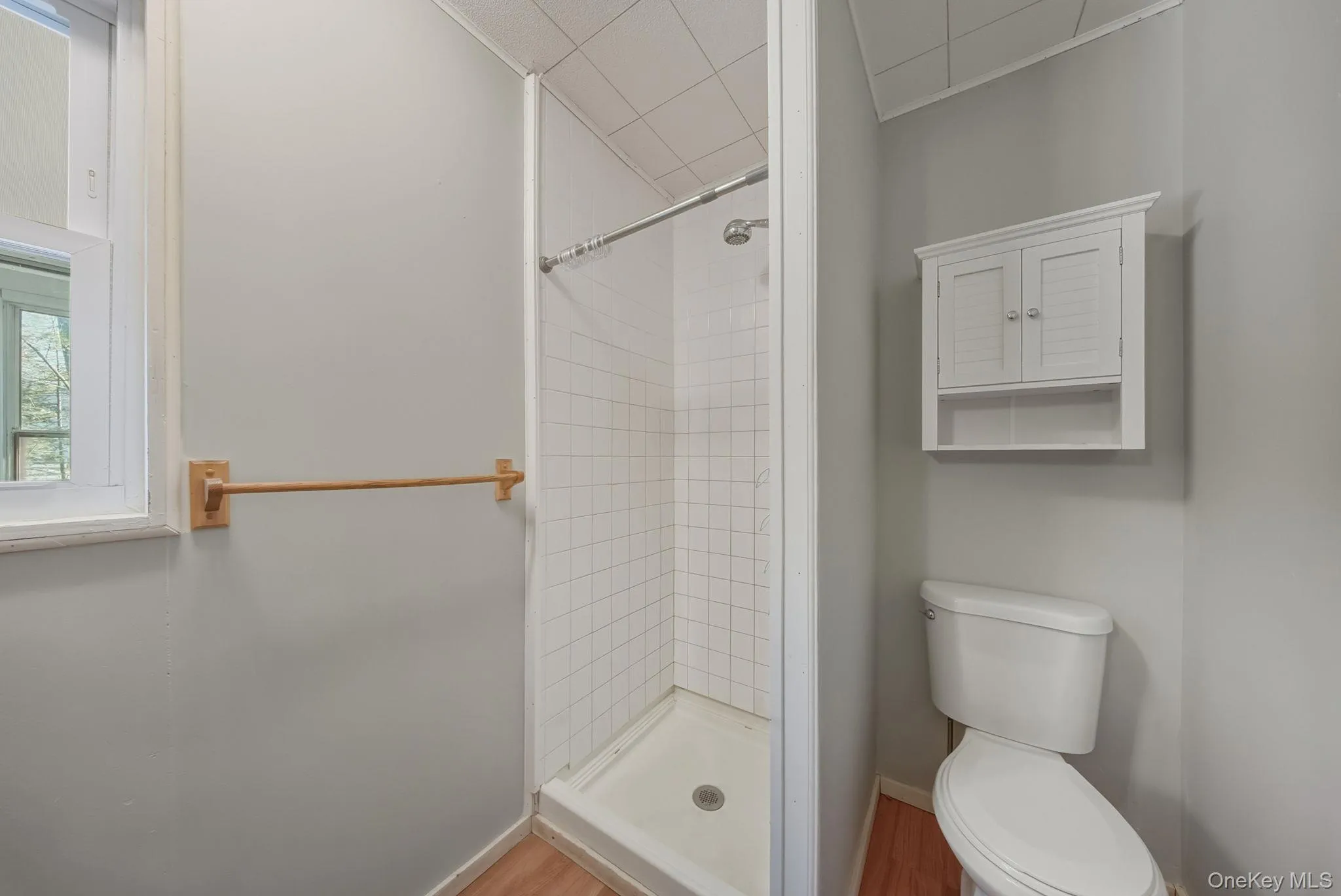 Full bathroom with a stall shower and toilet Full bathroom with a stall shower and toilet