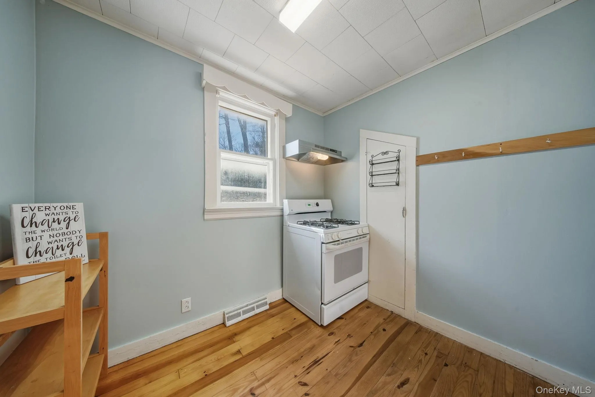 Kitchen featuring gas range gas stove, light wood-type flooring, and extractor fan Kitchen featuring gas range gas stove, light wood-type flooring, and extractor fan
