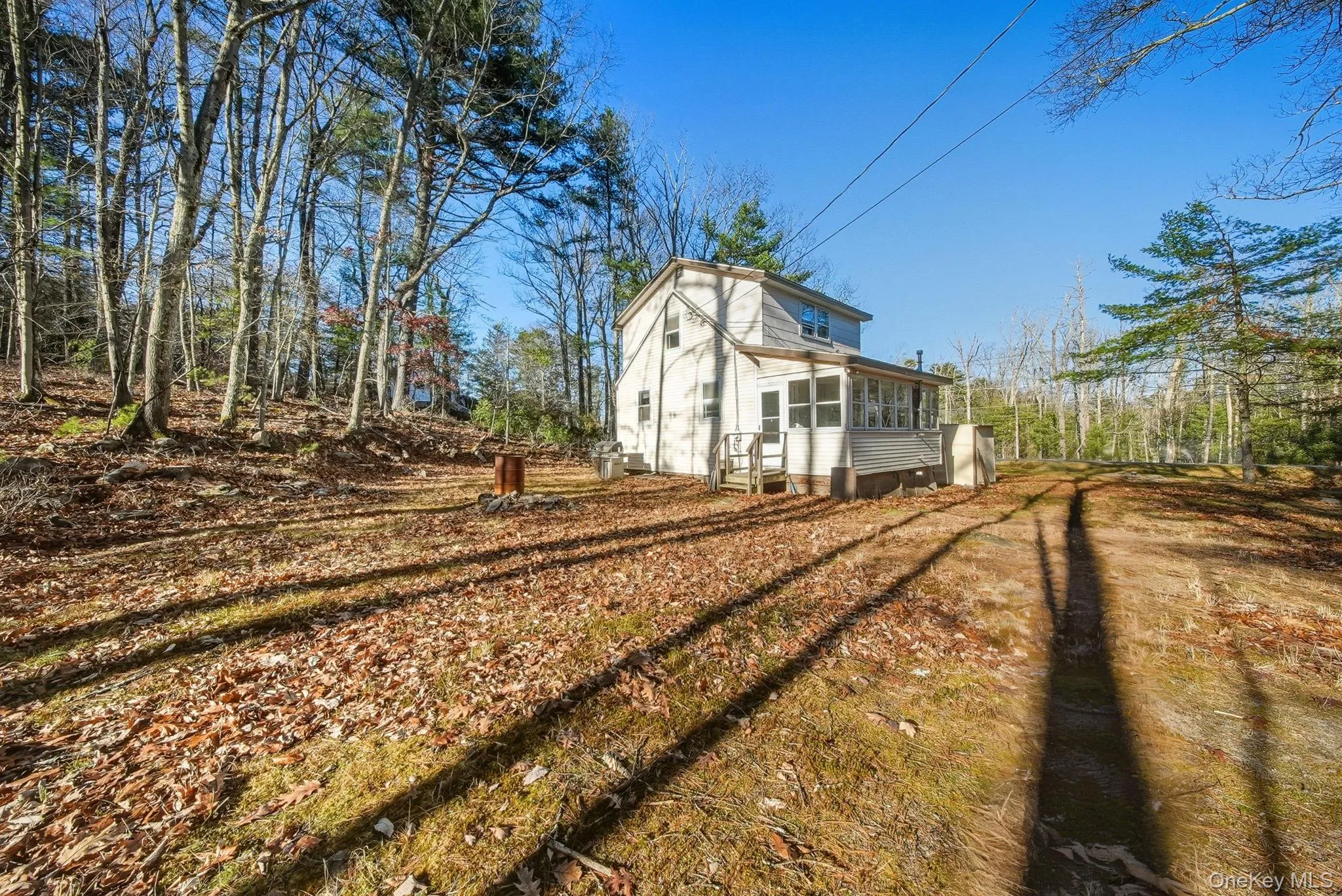 View of home's exterior with a sunroom View of home's exterior with a sunroom