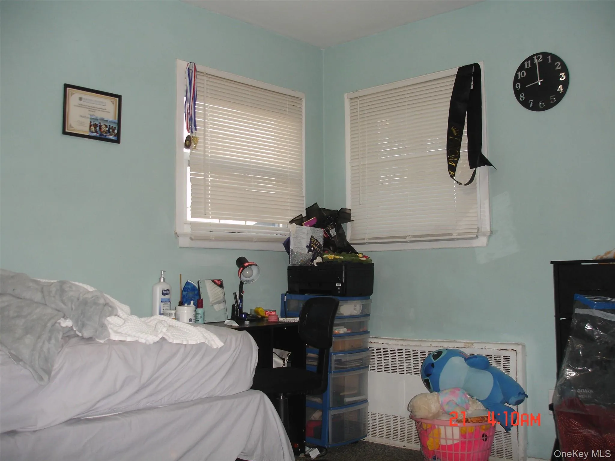 Bedroom with radiator and carpet floors Bedroom with radiator and carpet floors