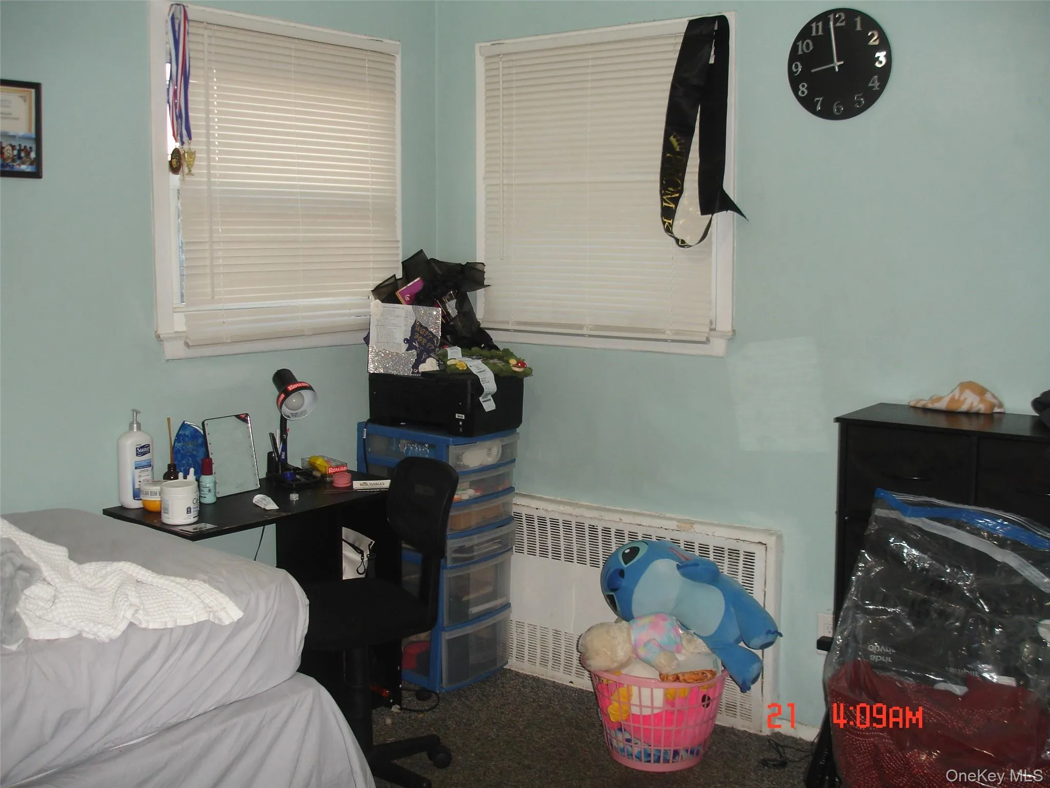 Carpeted bedroom featuring radiator heating unit Carpeted bedroom featuring radiator heating unit