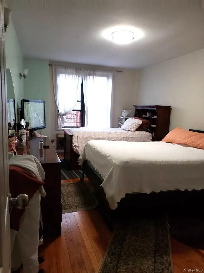 Bedroom featuring dark wood-style floors Bedroom featuring dark wood-style floors