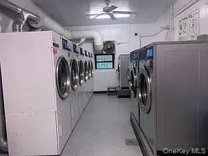 Washroom featuring washer and clothes dryer and ceiling fan Washroom featuring washer and clothes dryer and ceiling fan