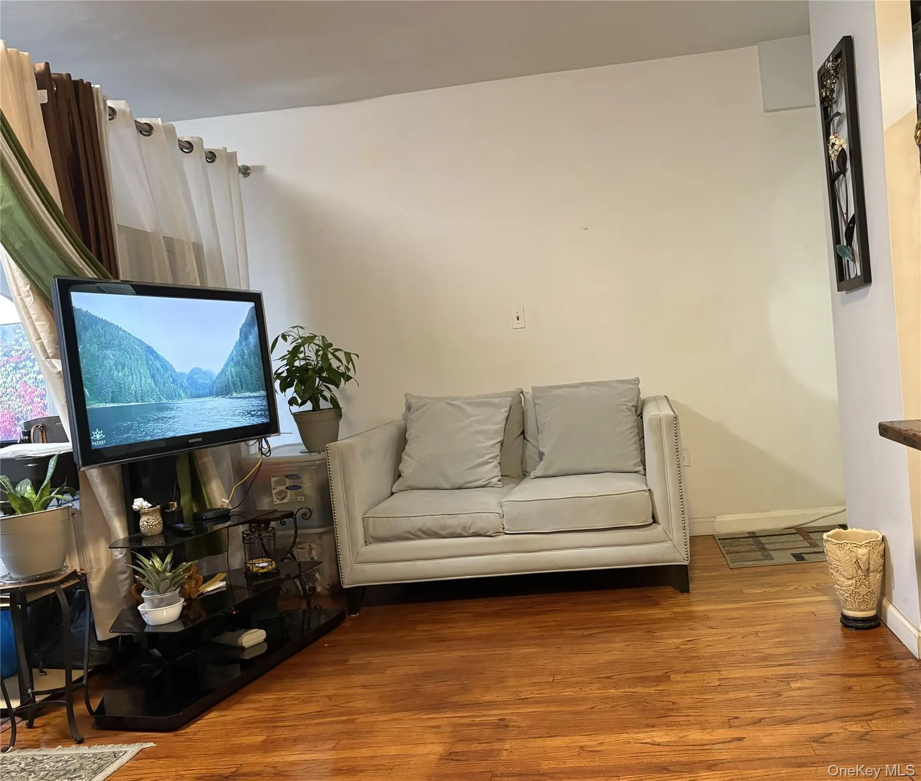 Sitting room featuring wood finished floors and baseboards Sitting room featuring wood finished floors and baseboards