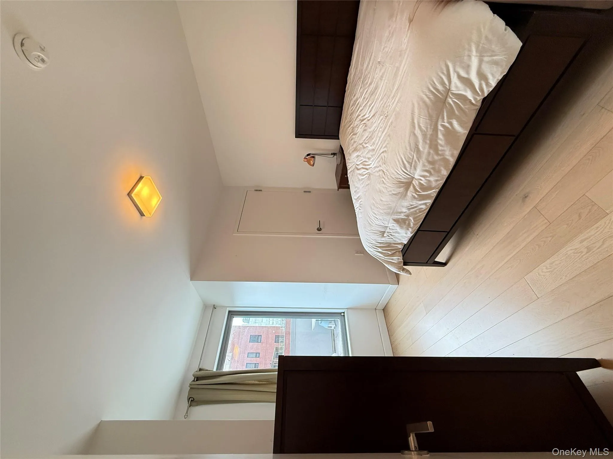 Bedroom with light wood finished floors and baseboards Bedroom with light wood finished floors and baseboards