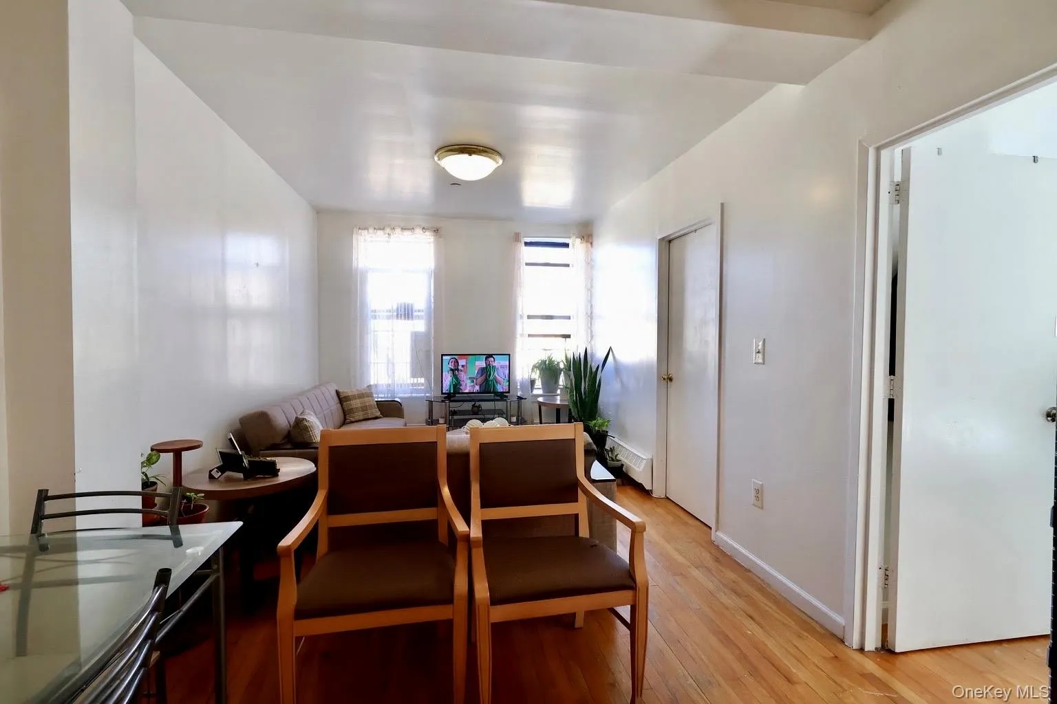 Dining room with light wood finished floors and a baseboard heating unit Dining room with light wood finished floors and a baseboard heating unit