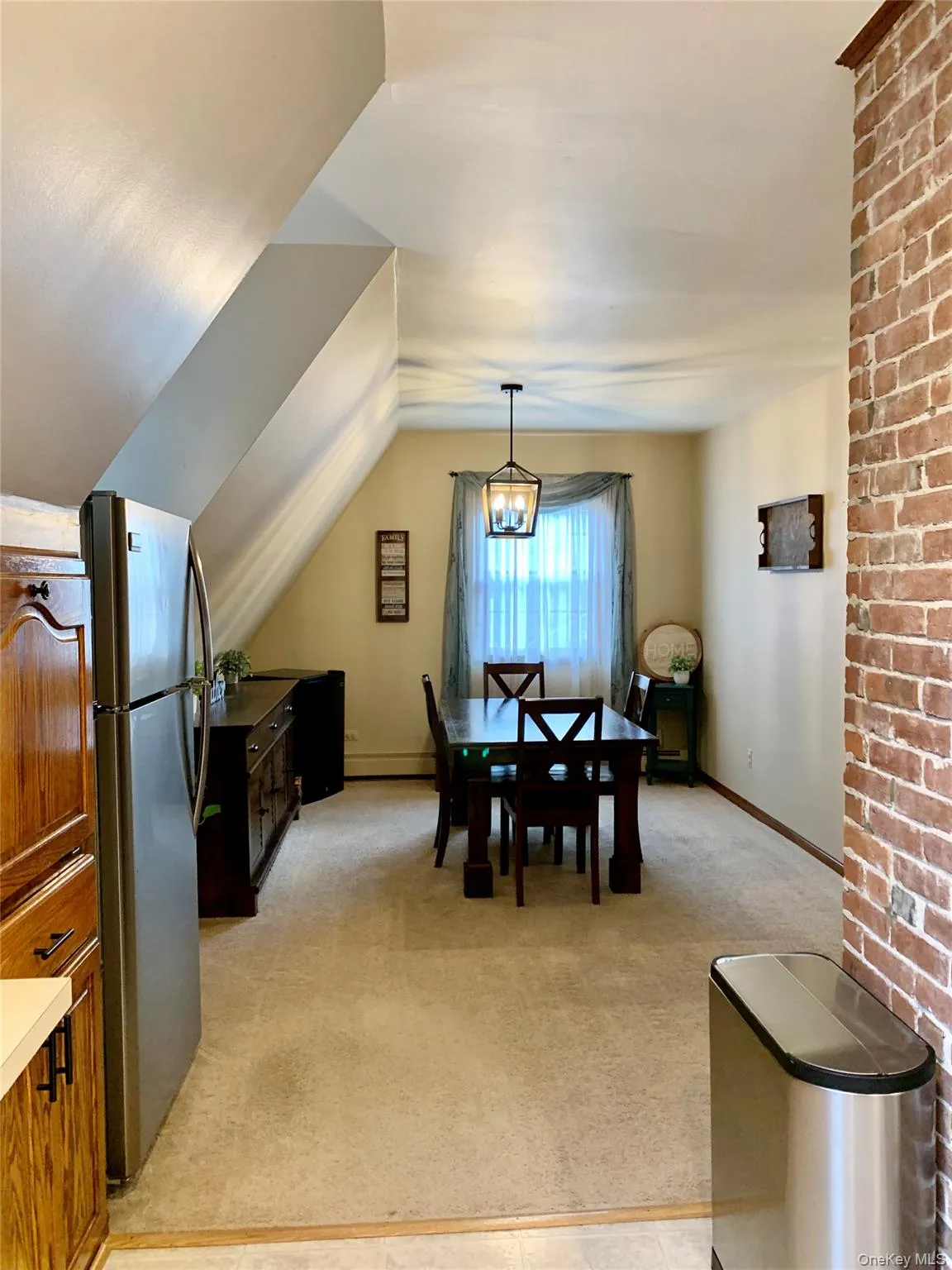 Dining room with light carpet and vaulted ceiling Dining room with light carpet and vaulted ceiling