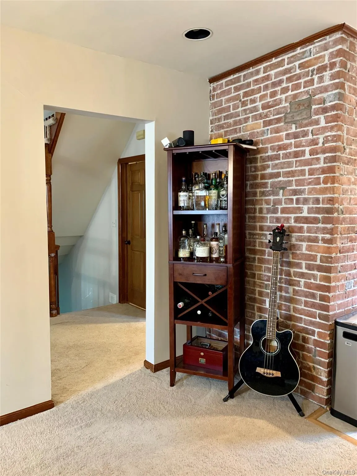 Bar area with light carpet and brick wall Bar area with light carpet and brick wall