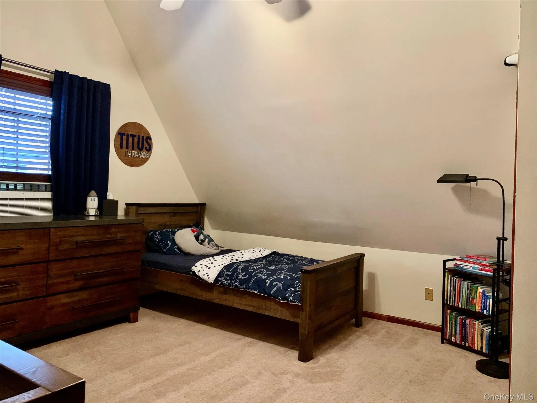 Bedroom featuring vaulted ceiling, light colored carpet, and a ceiling fan Bedroom featuring vaulted ceiling, light colored carpet, and a ceiling fan