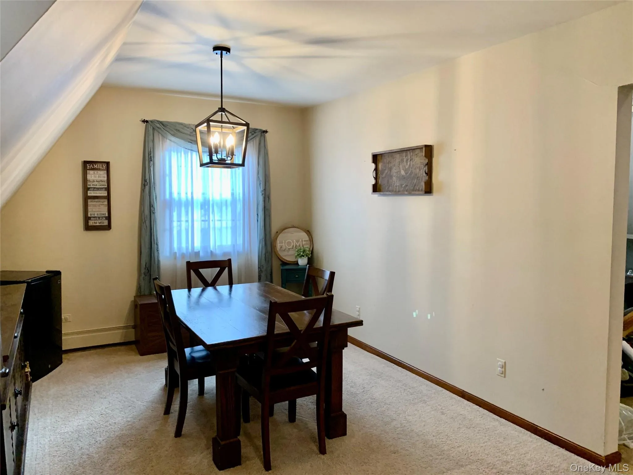 Dining room featuring light colored carpet and a chandelier Dining room featuring light colored carpet and a chandelier