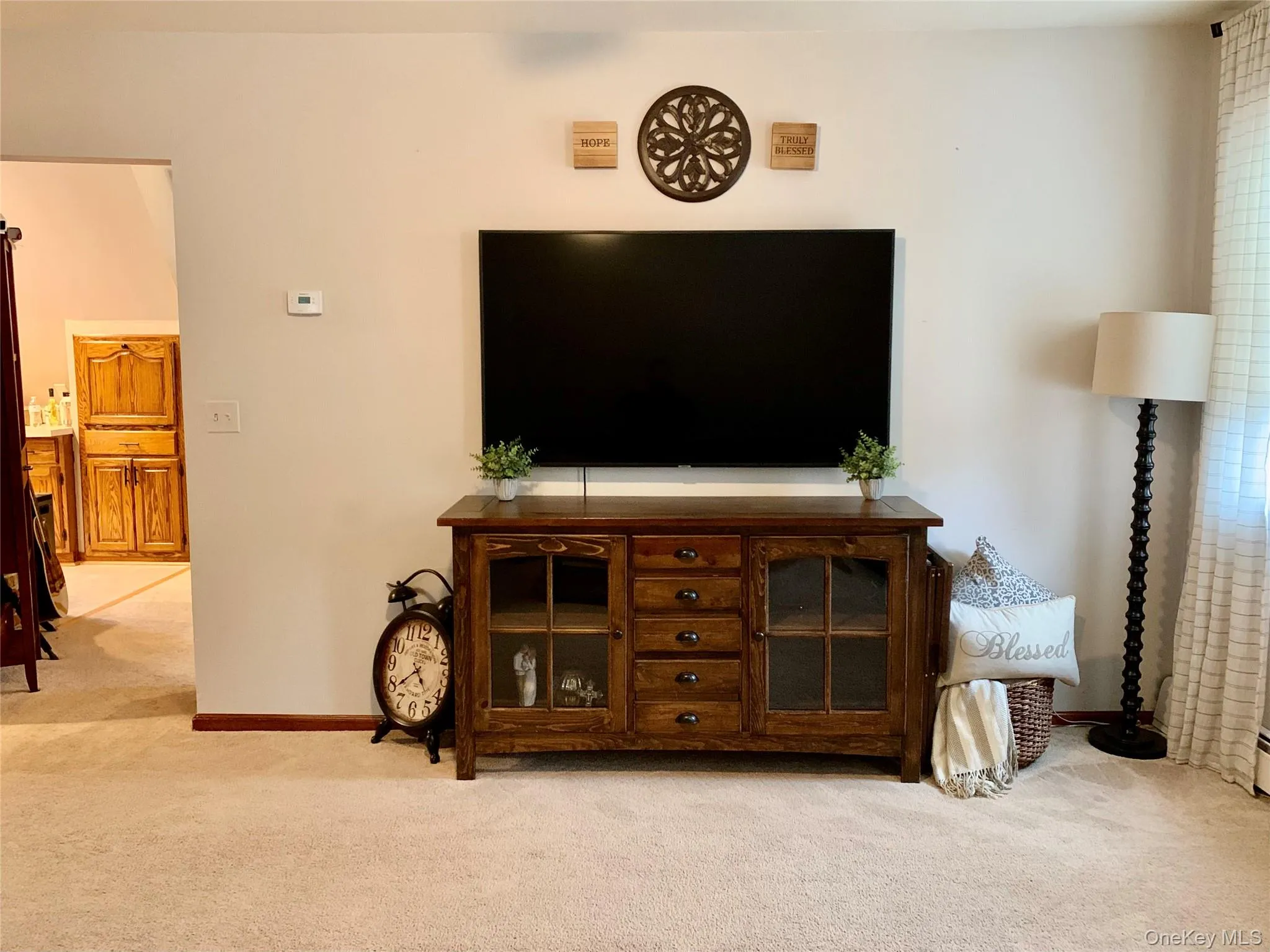 Living area with carpet flooring Living area with carpet flooring