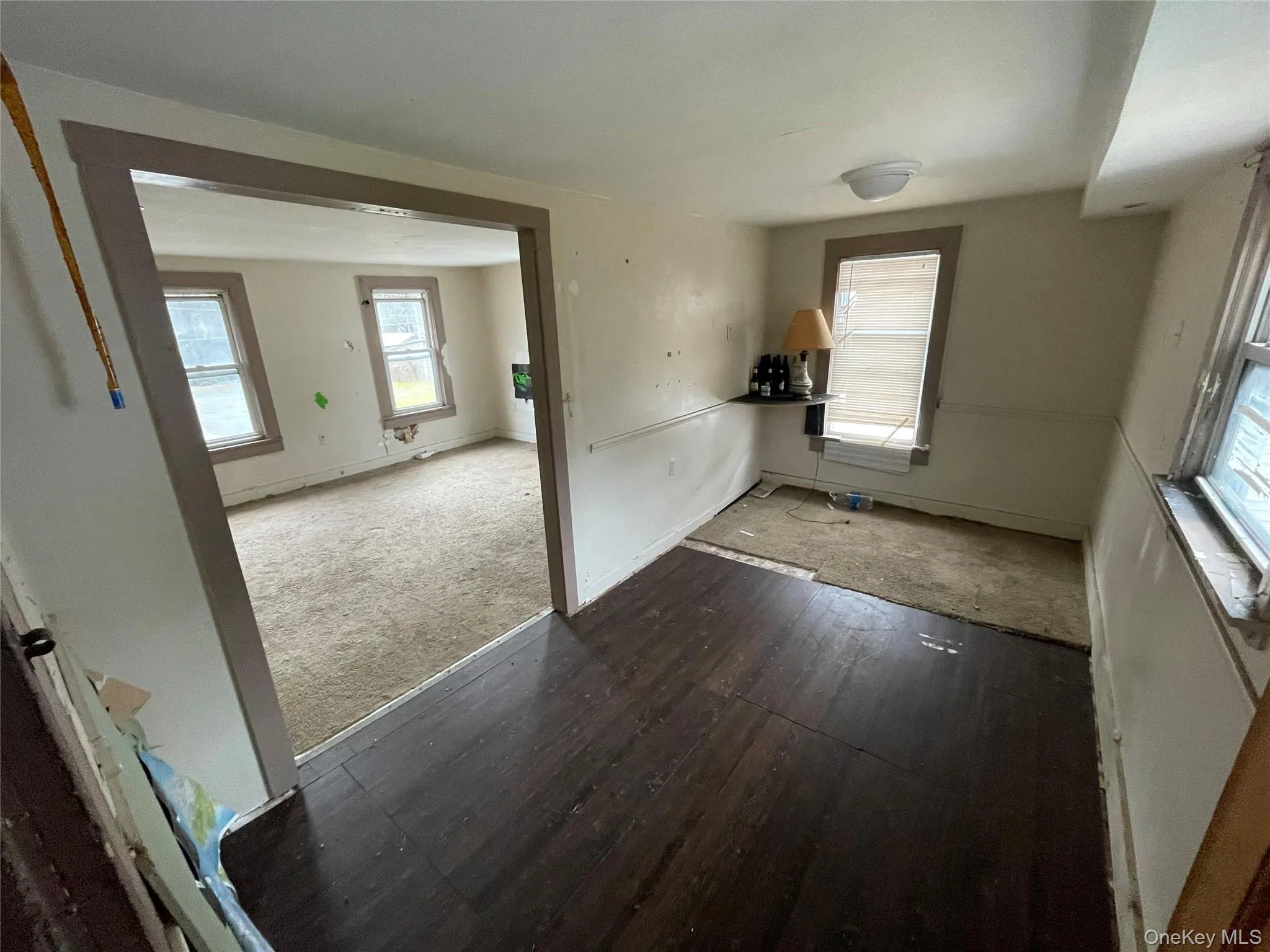 Spare room with dark carpet and dark wood-type flooring Spare room with dark carpet and dark wood-type flooring