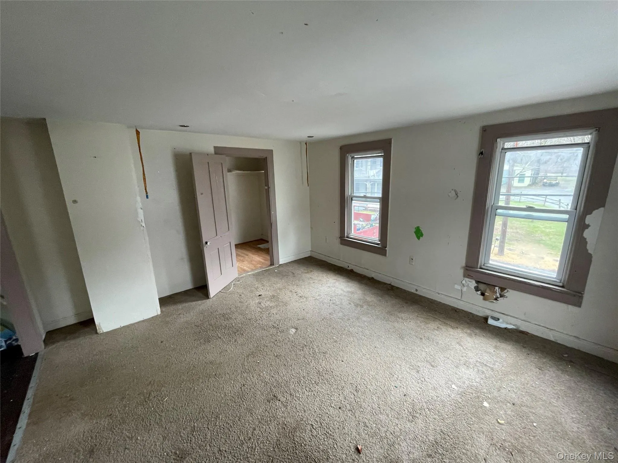 Unfurnished bedroom with carpet and a closet Unfurnished bedroom with carpet and a closet