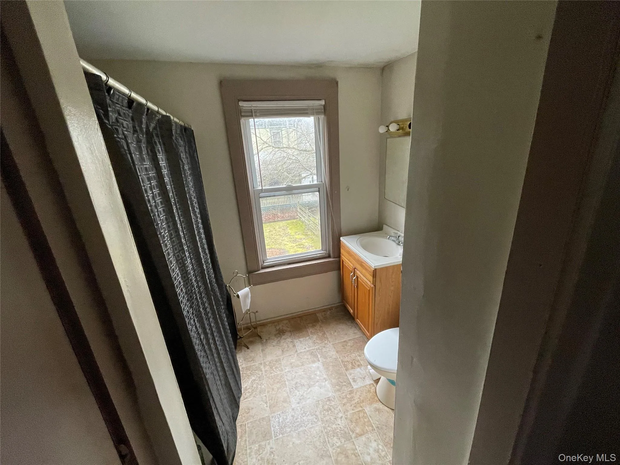 Bathroom with vanity and curtained shower Bathroom with vanity and curtained shower