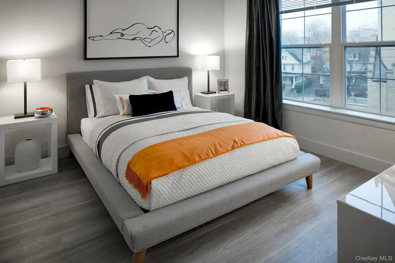 Bedroom featuring wood finished floors and baseboards Bedroom featuring wood finished floors and baseboards