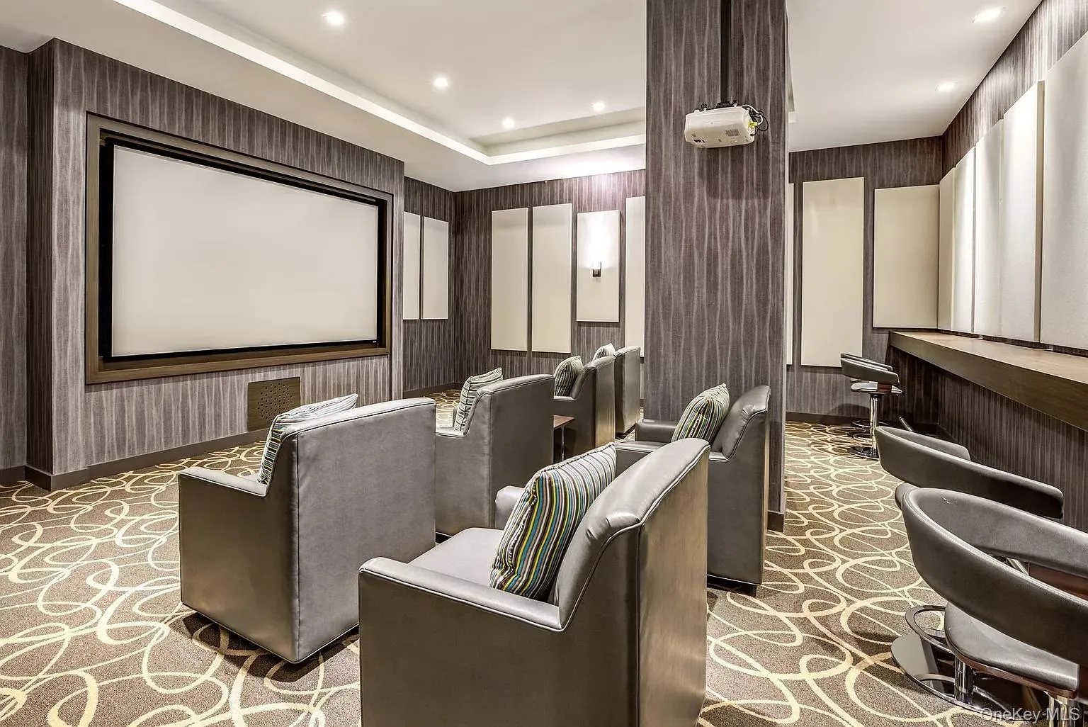 Home theater room with recessed lighting and wallpapered walls Home theater room with recessed lighting and wallpapered walls