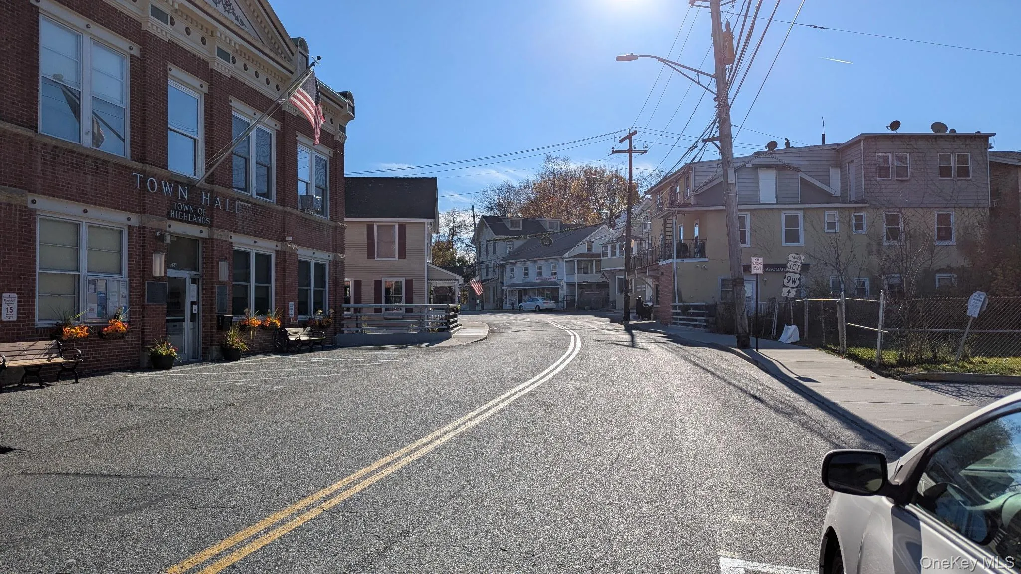 View of asphalt street with sidewalks, a residential view, and street lights View of asphalt street with sidewalks, a residential view, and street lights