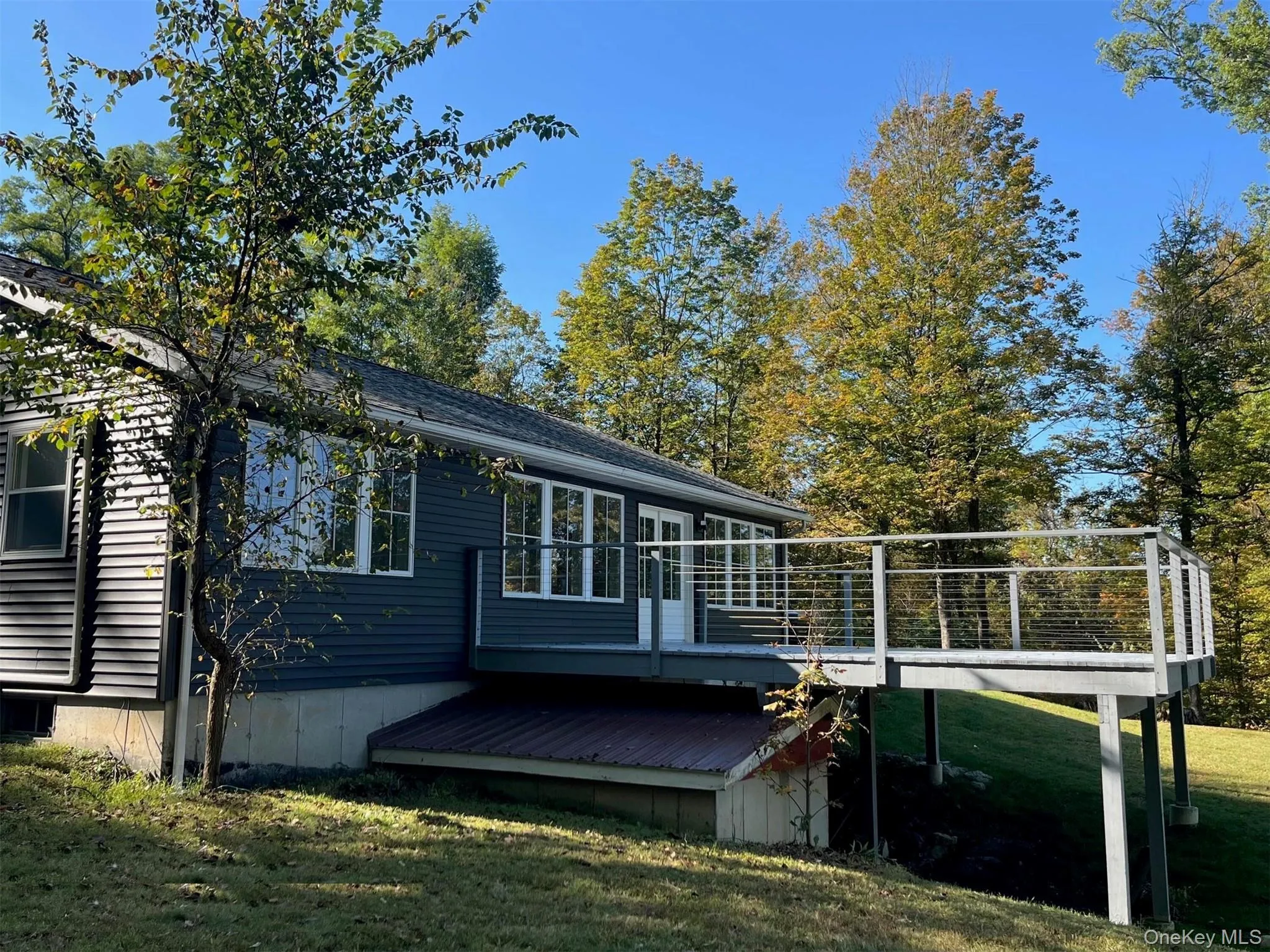 Rear view of property with a wooden deck, a yard, with view of the Hudson. Rear view of property with a wooden deck, a yard, with view of the Hudson.