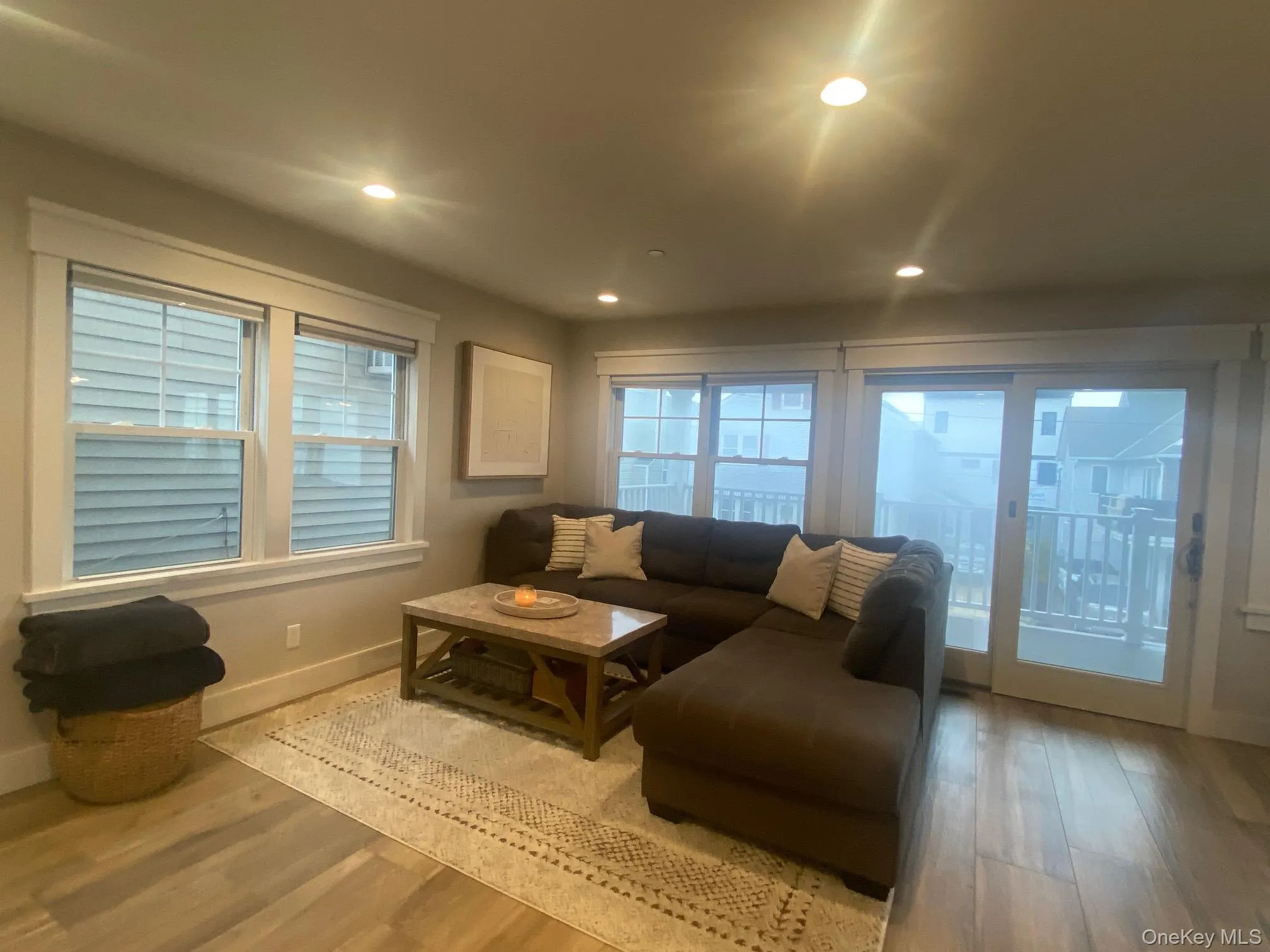 Living room featuring wood finished floors and recessed lighting Living room featuring wood finished floors and recessed lighting