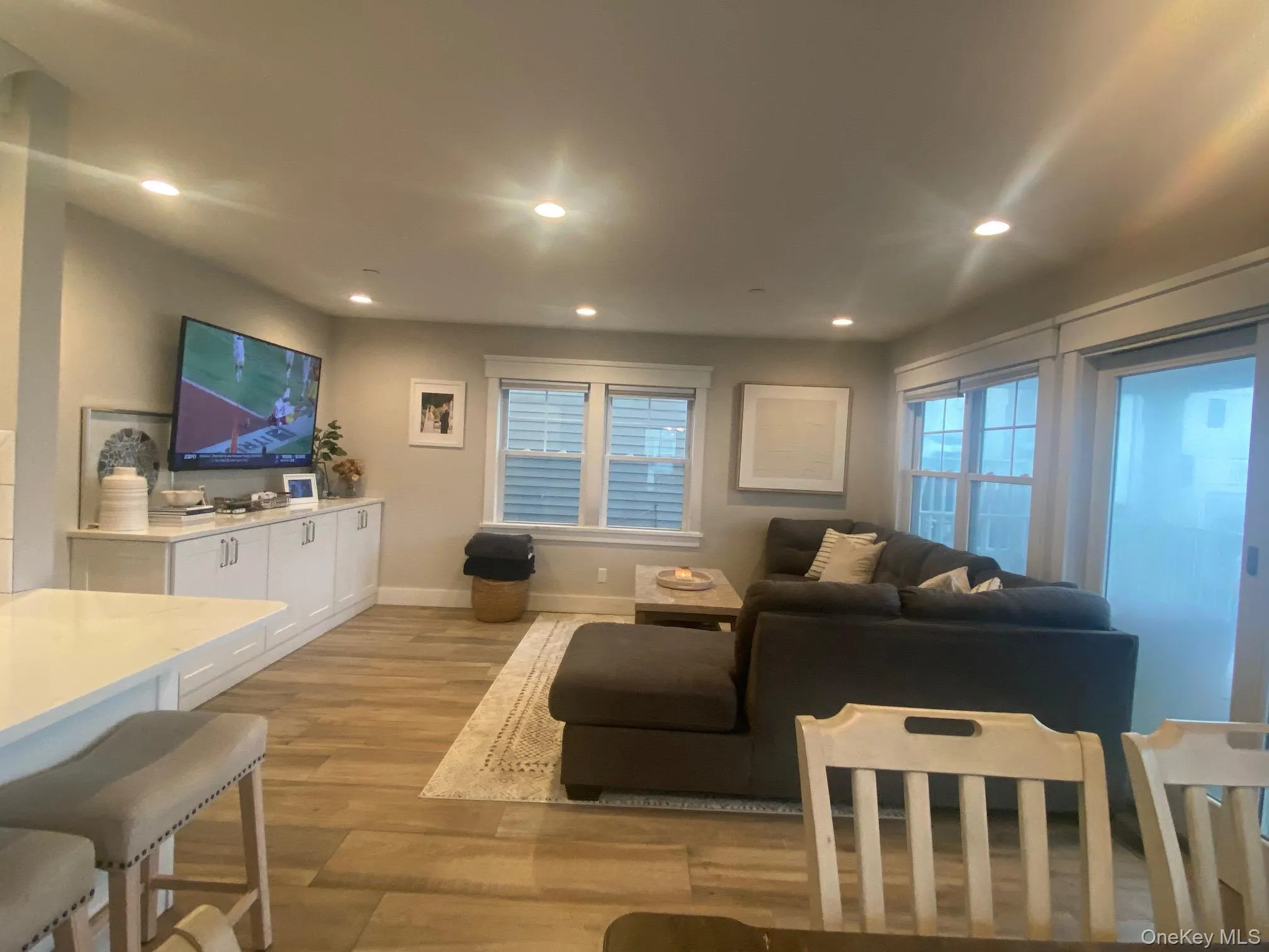 Living area featuring light wood-style flooring and recessed lighting Living area featuring light wood-style flooring and recessed lighting