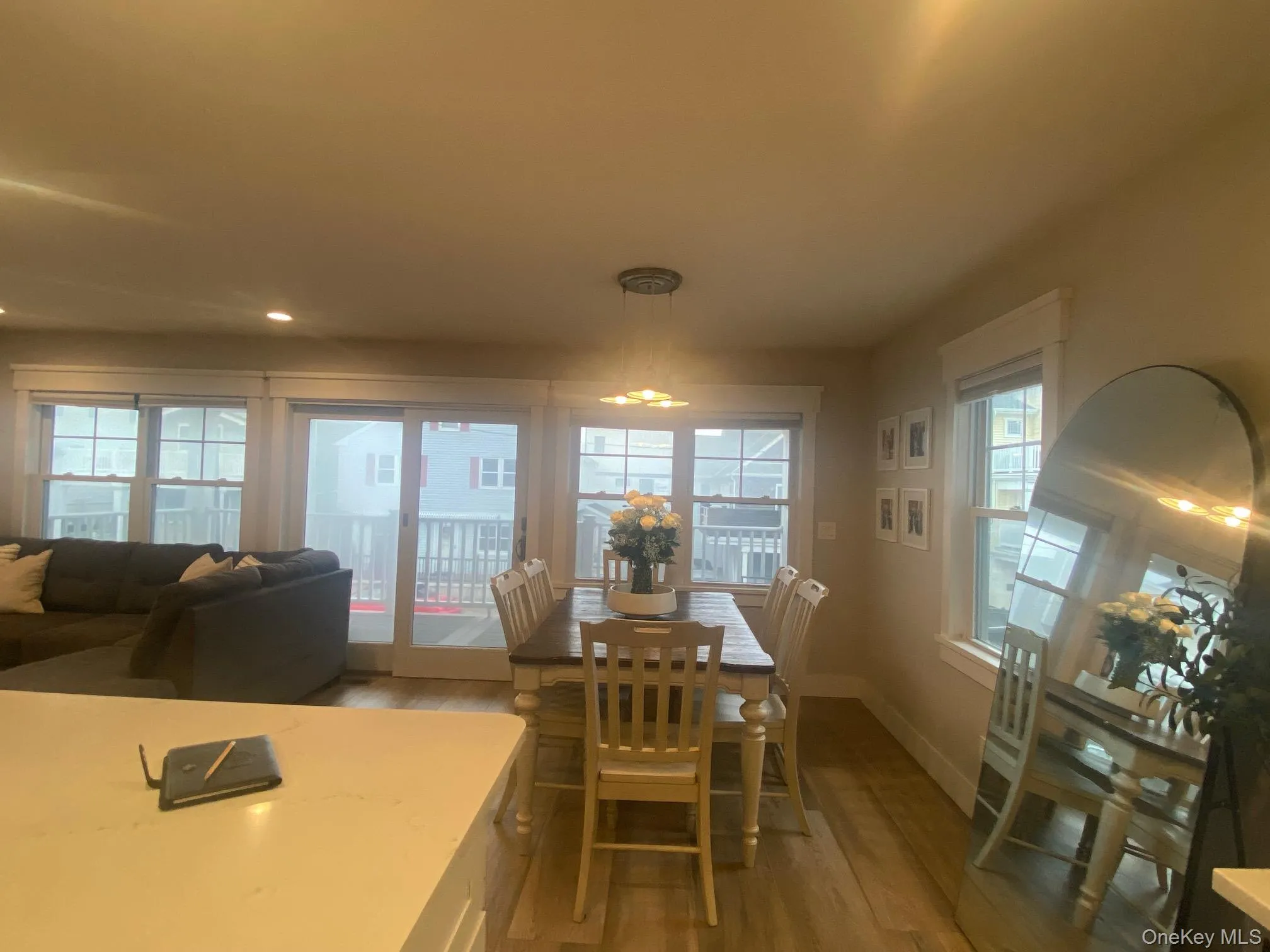 Dining space with light wood-style flooring and healthy amount of natural light Dining space with light wood-style flooring and healthy amount of natural light