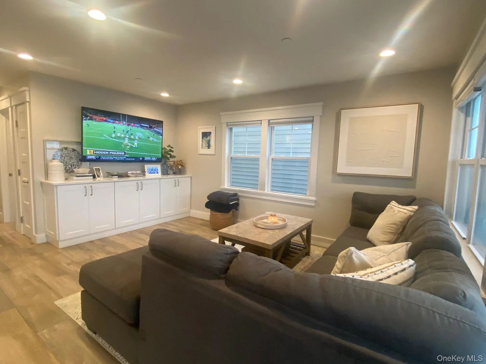 Living room featuring light wood finished floors and recessed lighting Living room featuring light wood finished floors and recessed lighting