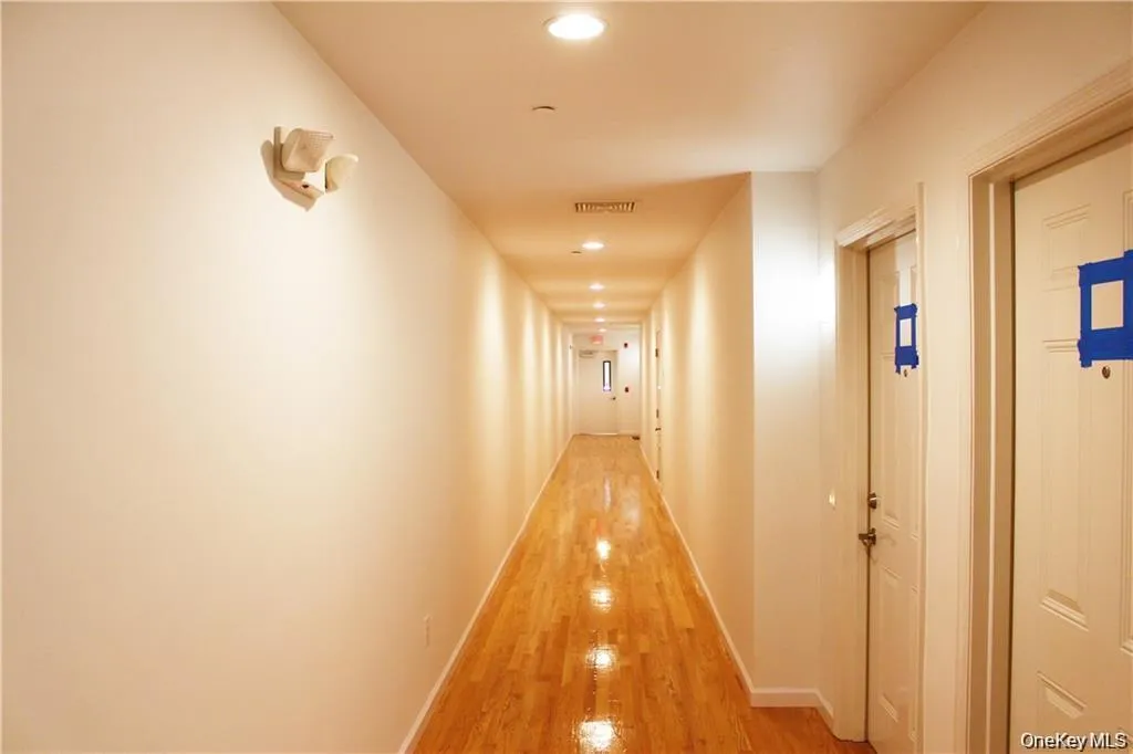 Corridor with recessed lighting and wood finished floors Corridor with recessed lighting and wood finished floors