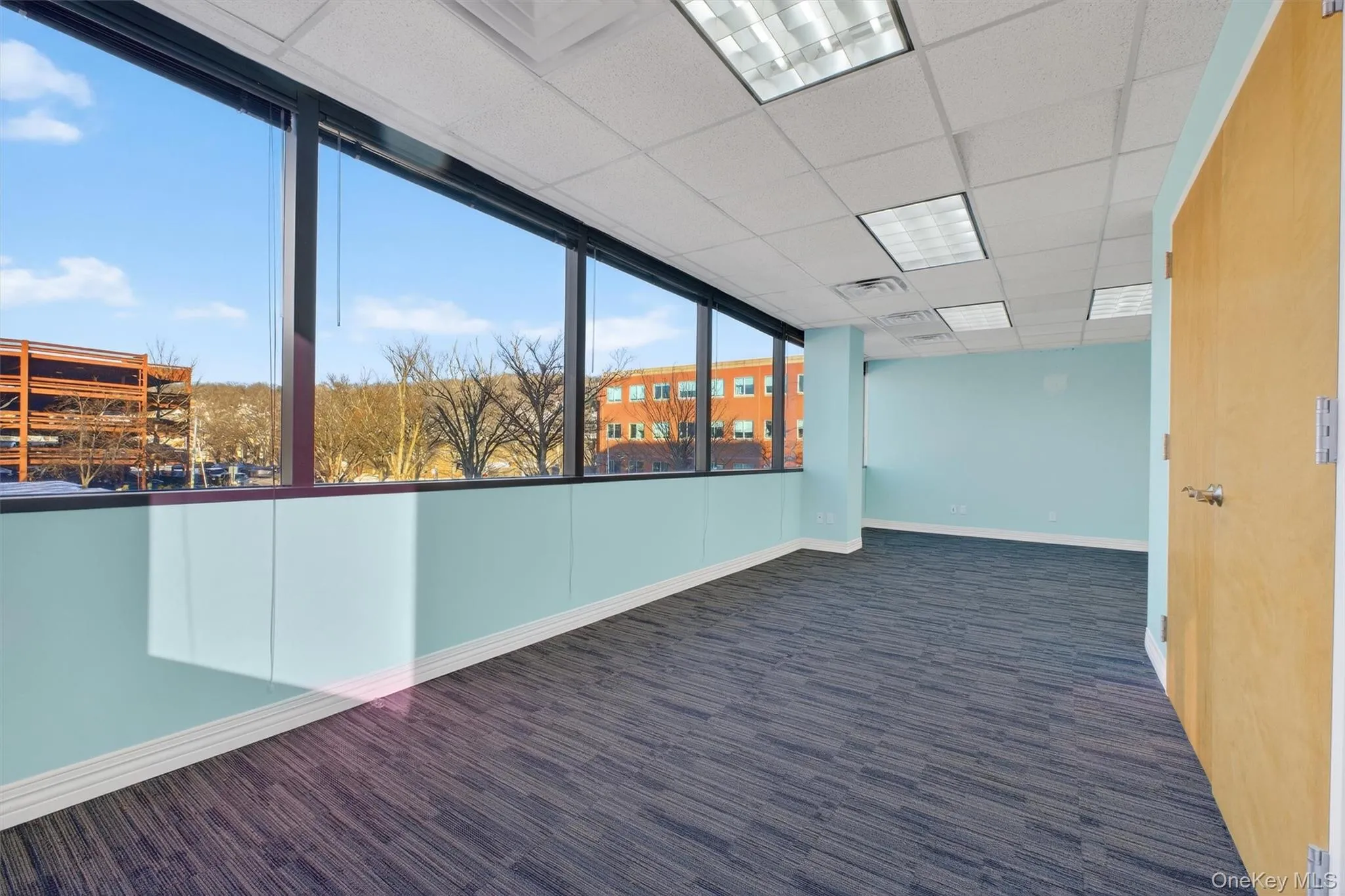 Empty room with baseboards and a paneled ceiling Empty room with baseboards and a paneled ceiling