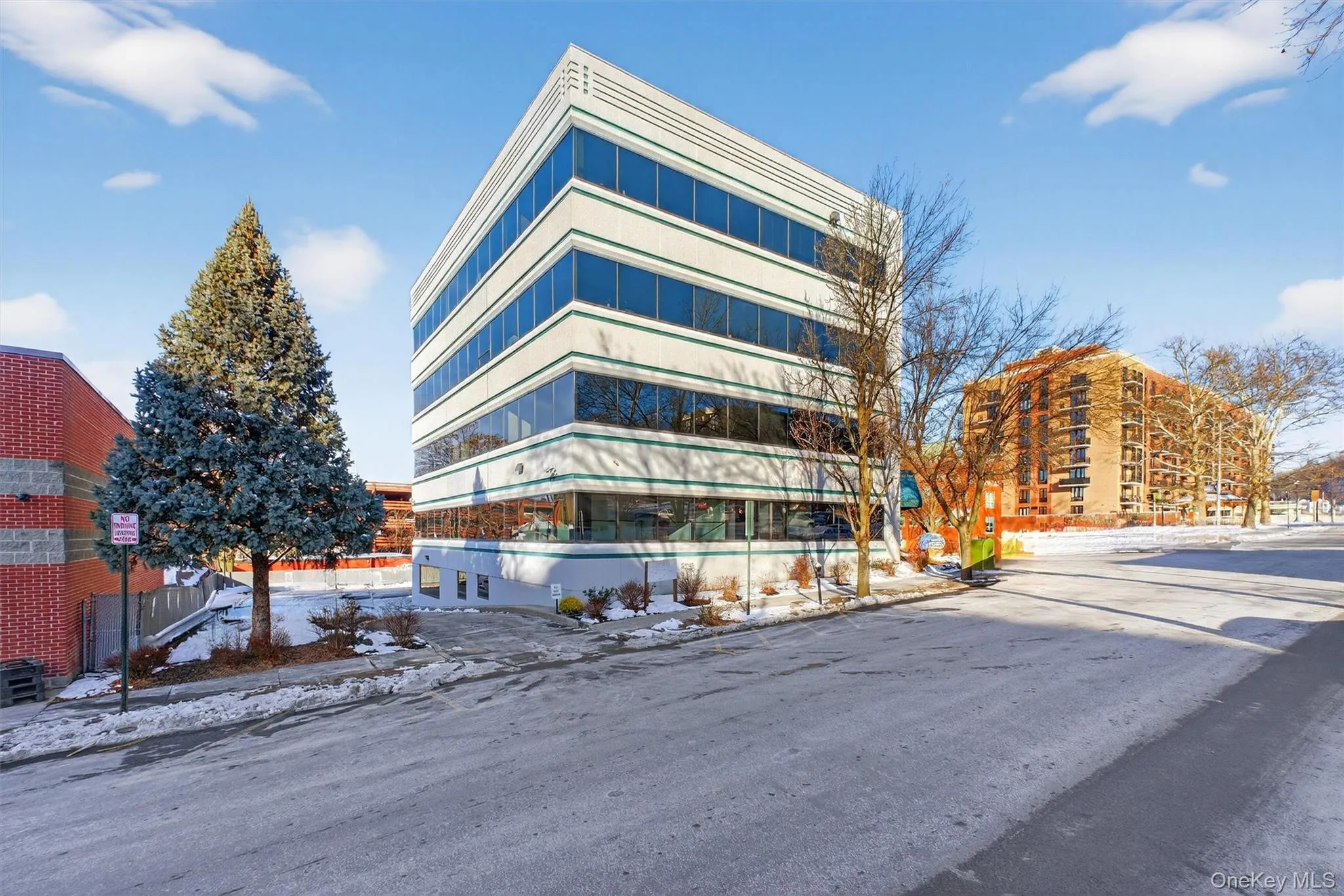 Snow covered property featuring a view of apartment building / complex Snow covered property featuring a view of apartment building / complex