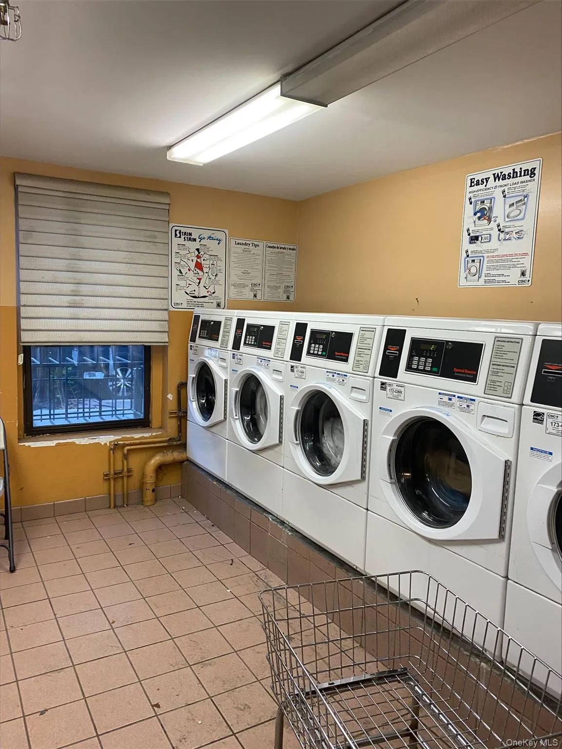 Communal laundry room with washer and dryer Communal laundry room with washer and dryer