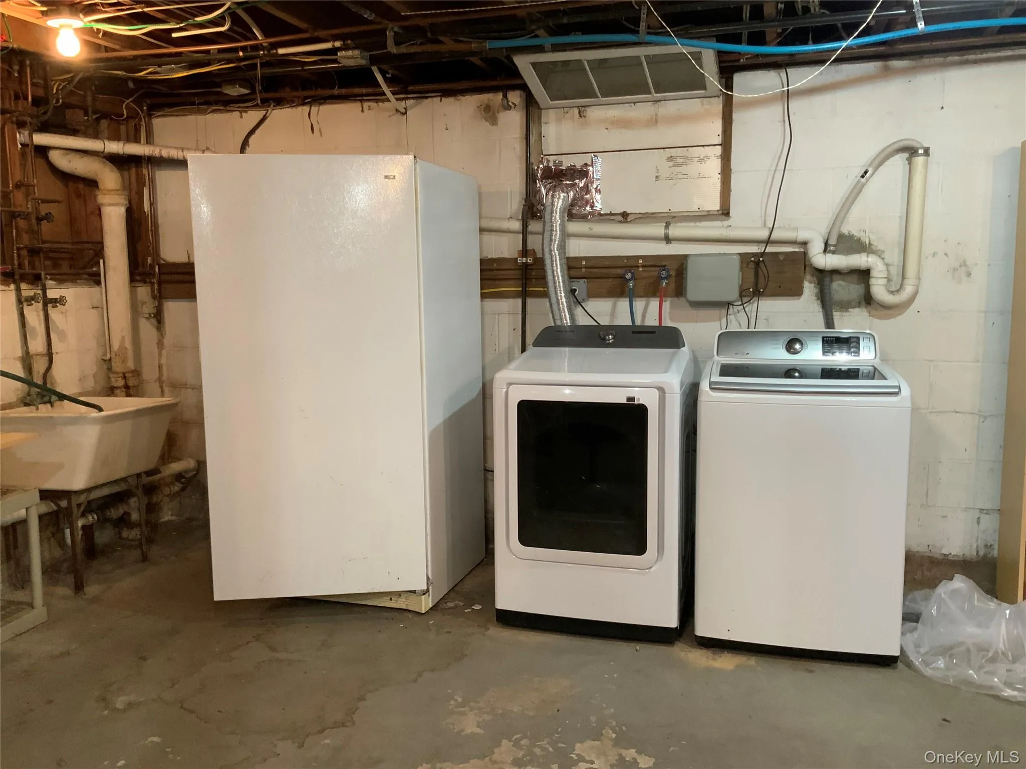 Laundry area with concrete floors and washing machine and dryer Laundry area with concrete floors and washing machine and dryer