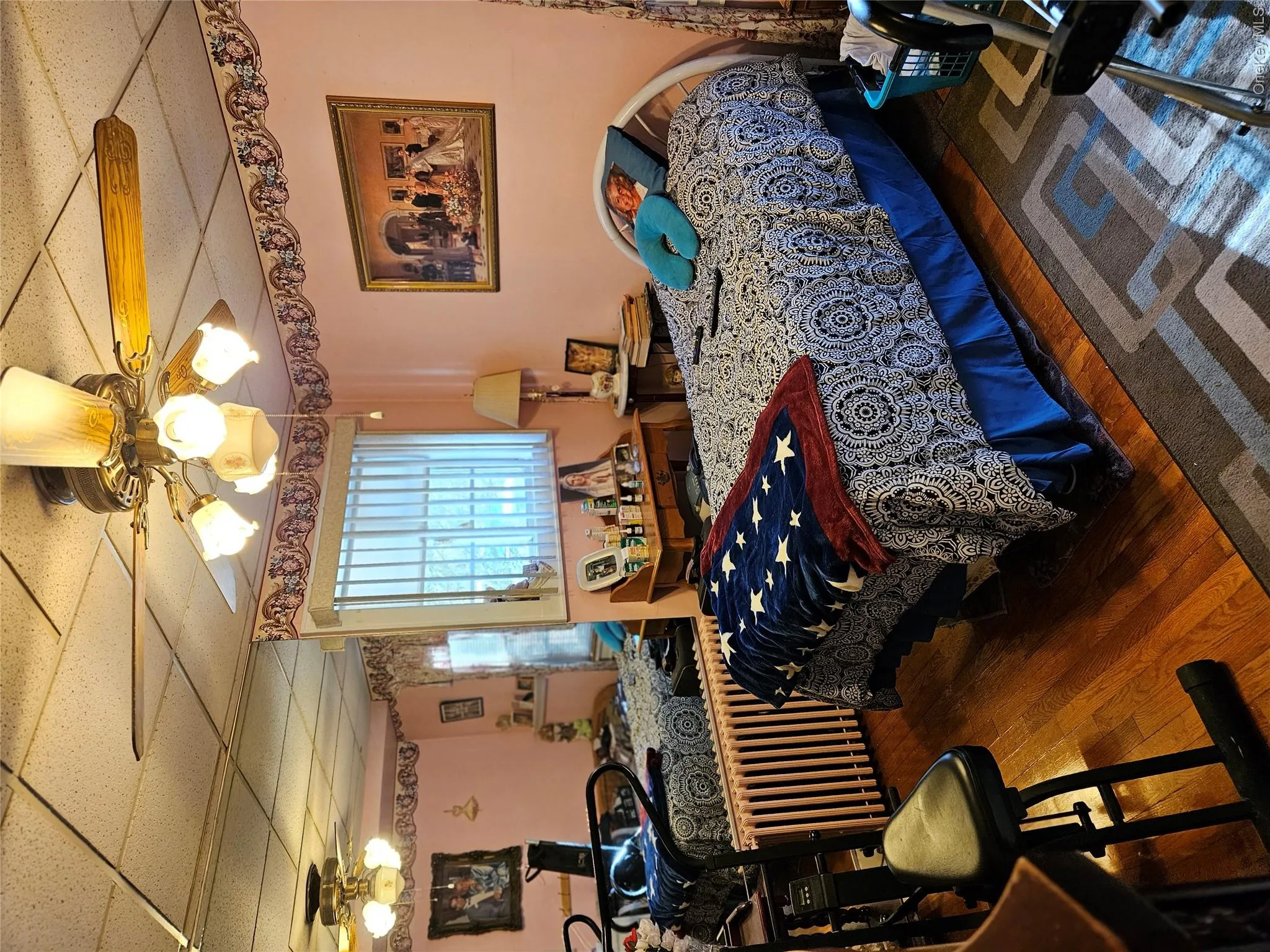 Bedroom featuring a drop ceiling, hardwood / wood-style flooring, and ceiling fan Bedroom featuring a drop ceiling, hardwood / wood-style flooring, and ceiling fan