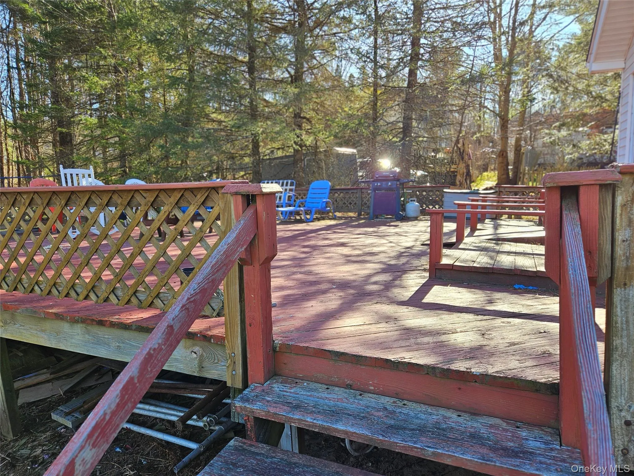 Wooden deck featuring a grill Wooden deck featuring a grill